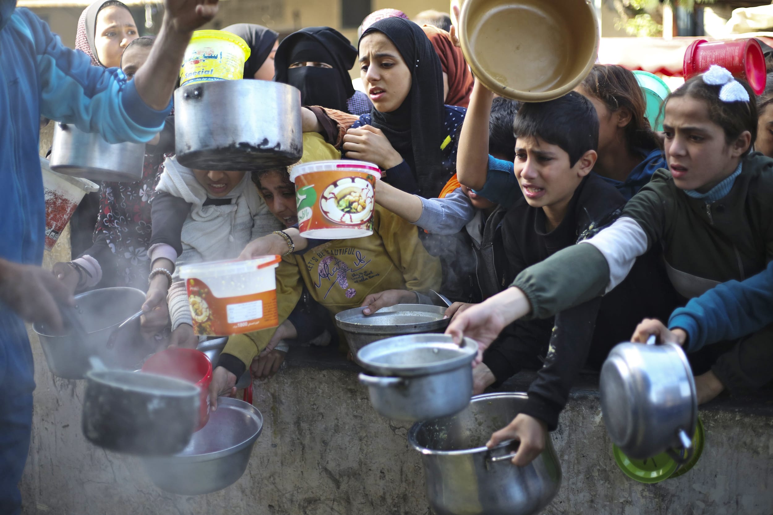 Palestinians line up for a free meal in Rafah, Gaza Strip, on Dec. 20, 2023.