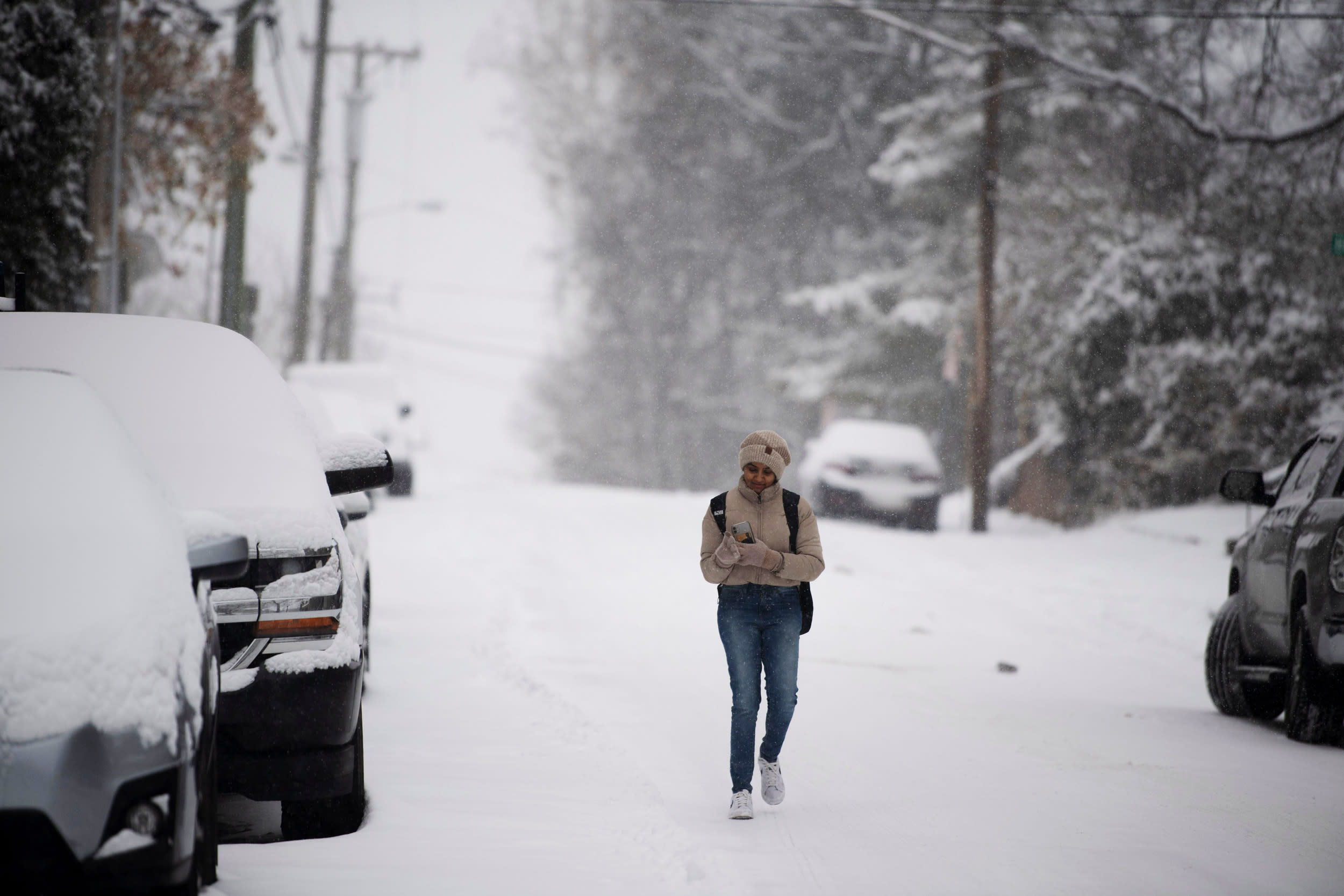 Sona Prakash walks through the snow to the bus stop in Nashville, Tenn., Monday, Jan. 15, 2024.