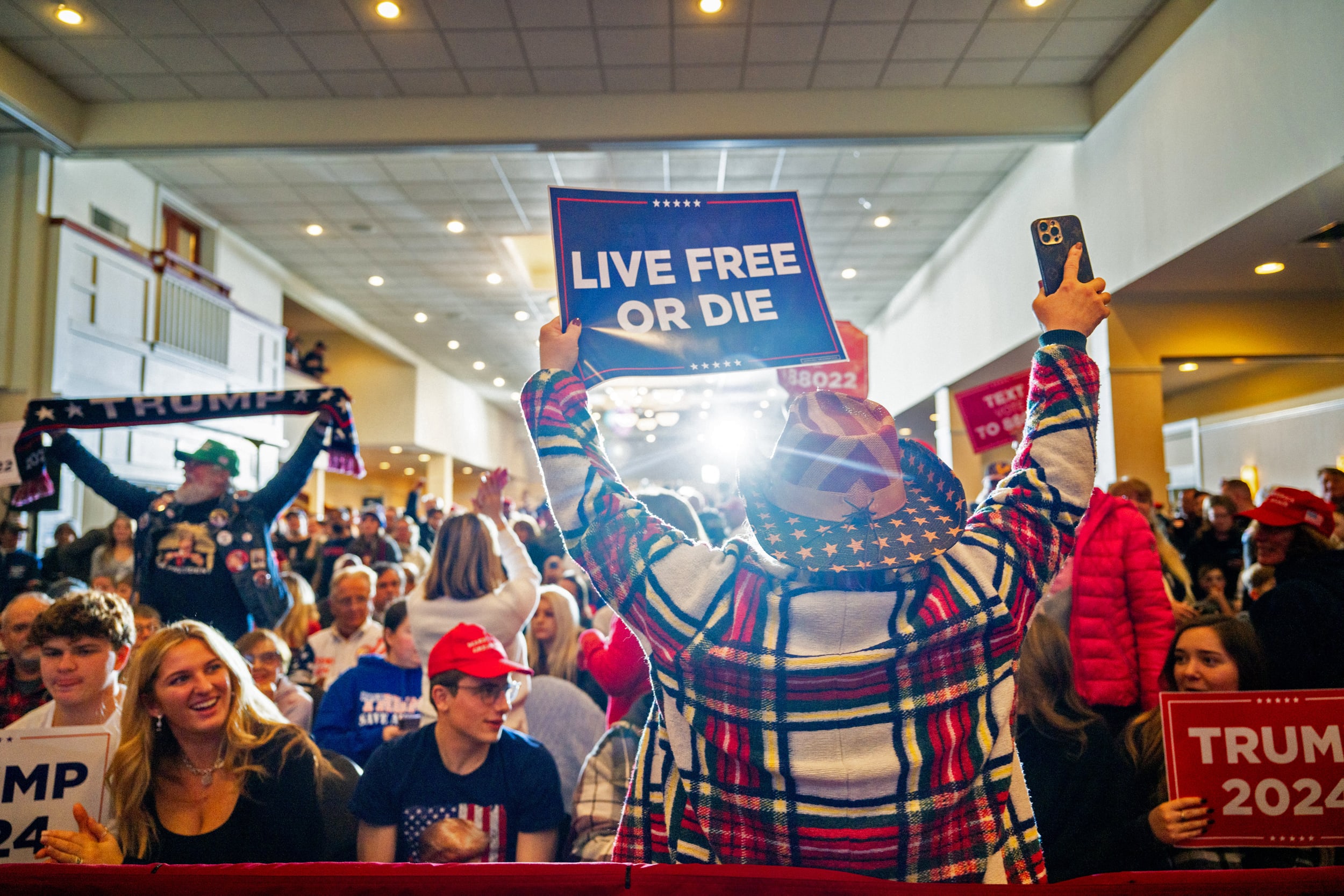 Supporter Kellie Dube rallies the crowd ahead of former President Donald Trump's speech during a rally at the Atkinson Country Club on Jan. 16, 2024 in Atkinson, N.H.