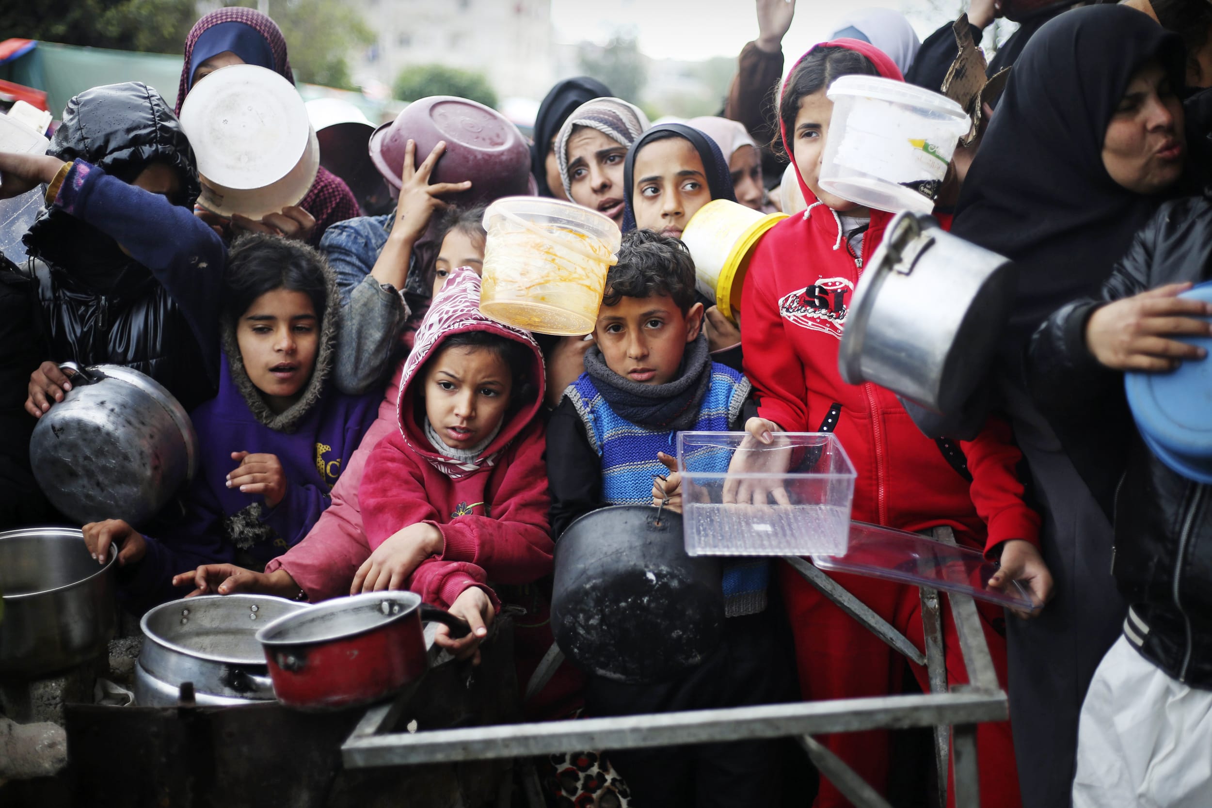 Palestinians line up for free food distribution in Khan Younis, Gaza Strip, Friday, Feb. 2, 2024. 