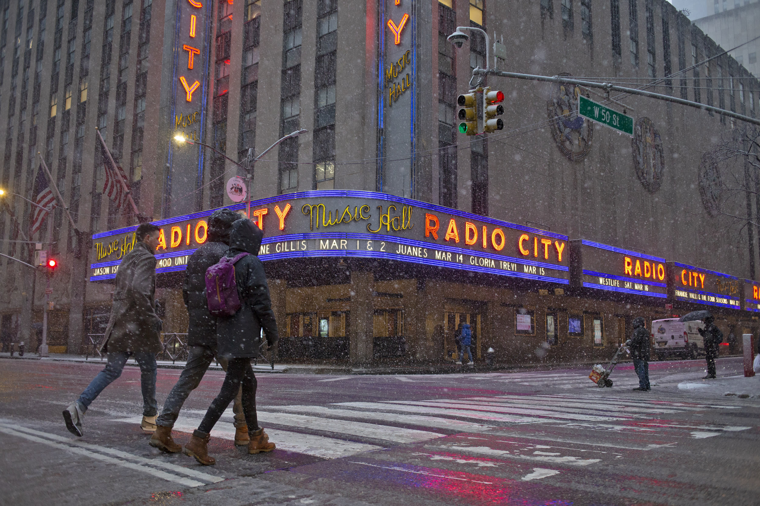 Snow falls in front of Radio City Music Hall in New York on Feb. 13, 2024.