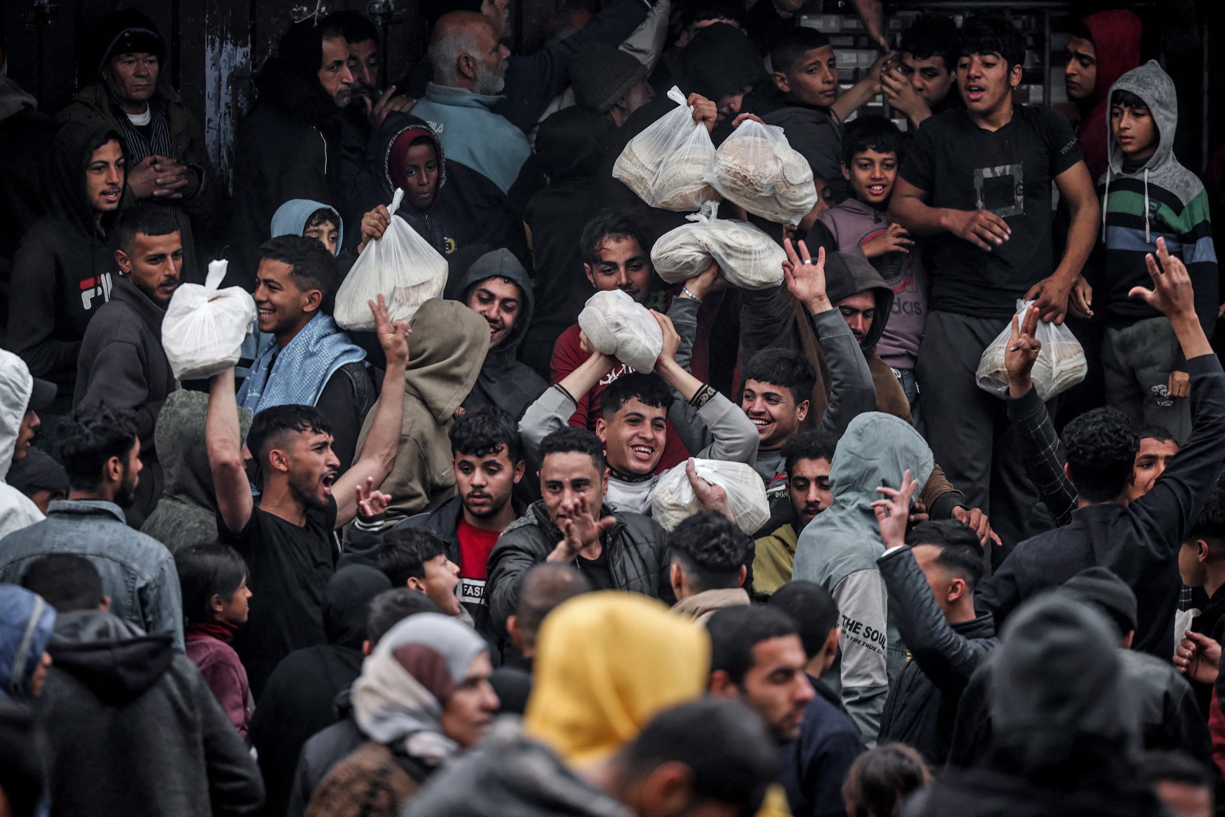 Palestinians crowd oustide a bakery to buy bread in Rafah, southern Gaza, on Feb. 15, 2024.
