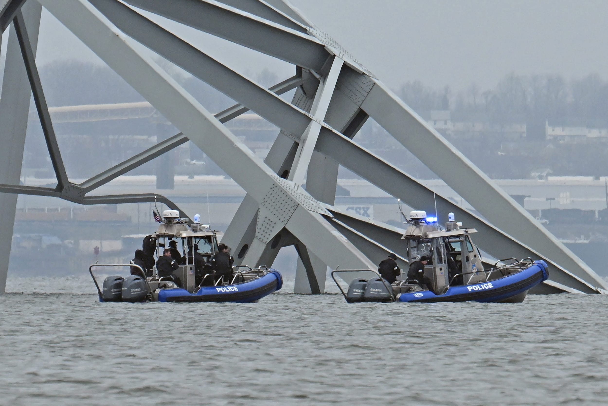 Police recovery crews work near the collapsed Francis Scott Key Bridge on March 27, 2024. 