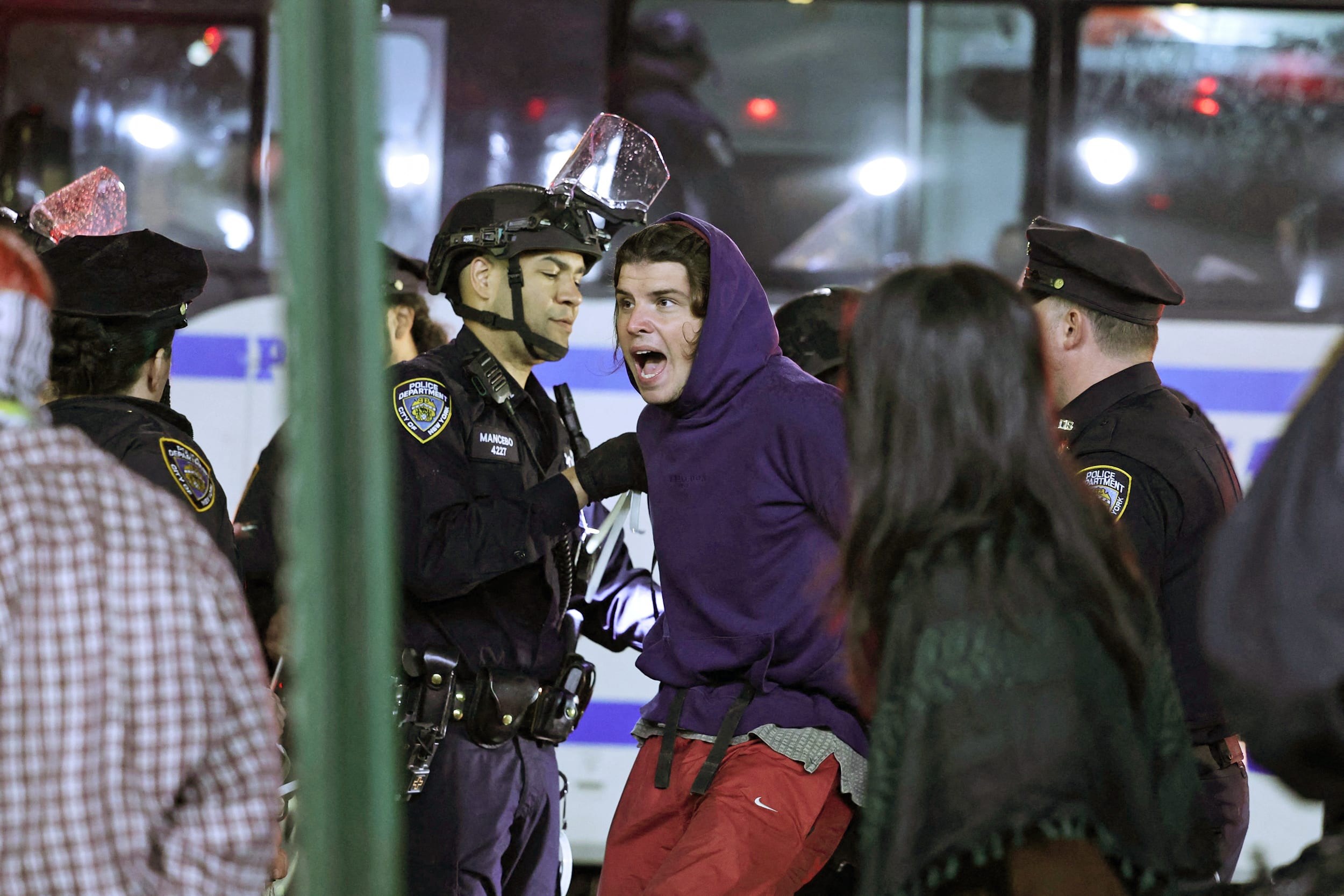 NYPD officers arrest students as they evict a building that had been barricaded by pro-Palestinian student protesters at Columbia University, in New York City on April 30, 2024. 