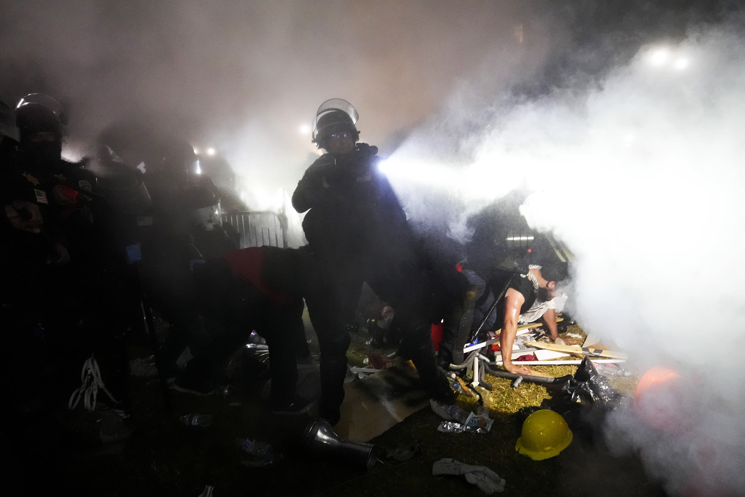 Police officers enter a pro-Palestinian encampment at UCLA.