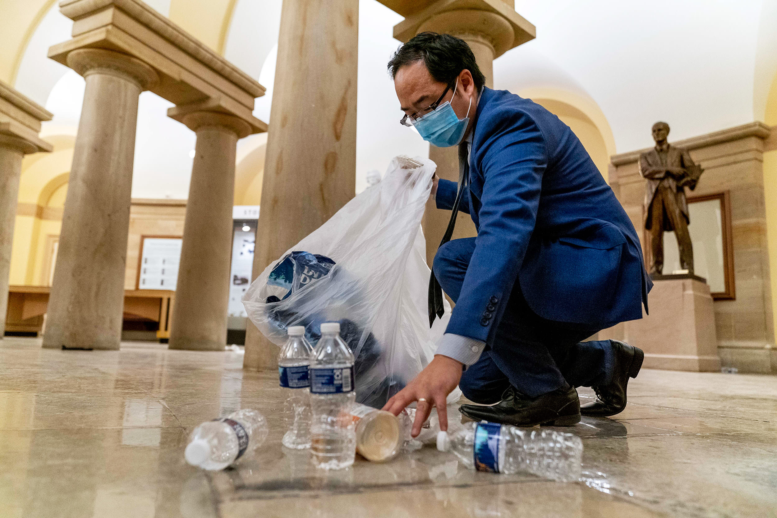 Rep. Andy Kim, D-N.J., cleans up debris and trash strewn