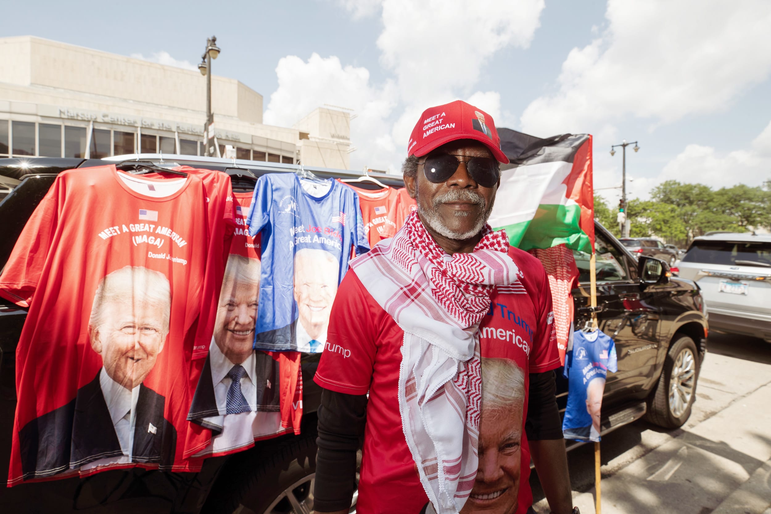 Francoise Demonique, from Detroit, arrived in Milwaukee at 3:00 a.m. to set up a mobile merchandise stand that sells unofficial candidate T-shirts emblazoned with the faces of Trump and Biden.