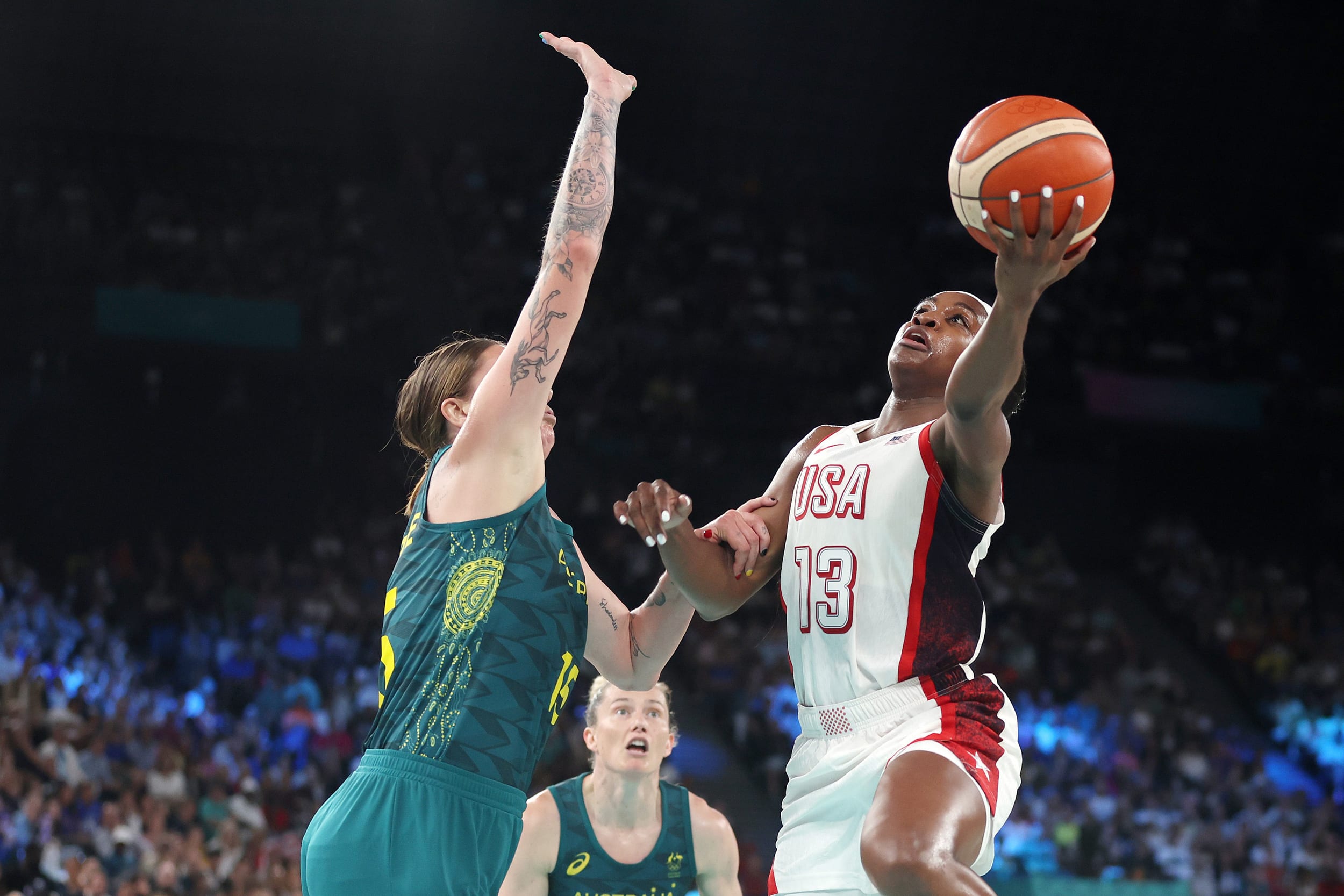 Jackie Young #13 of Team United States goes up for a basket over Cayla George #15 of Team Australia 