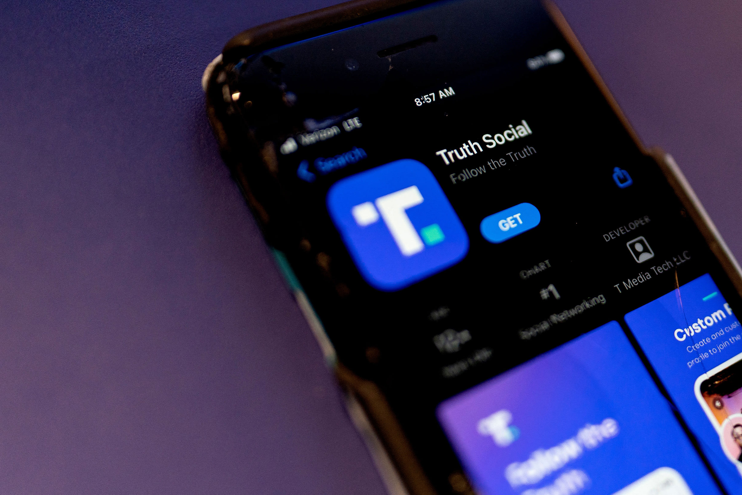 A phone screen displays the Truth Social app