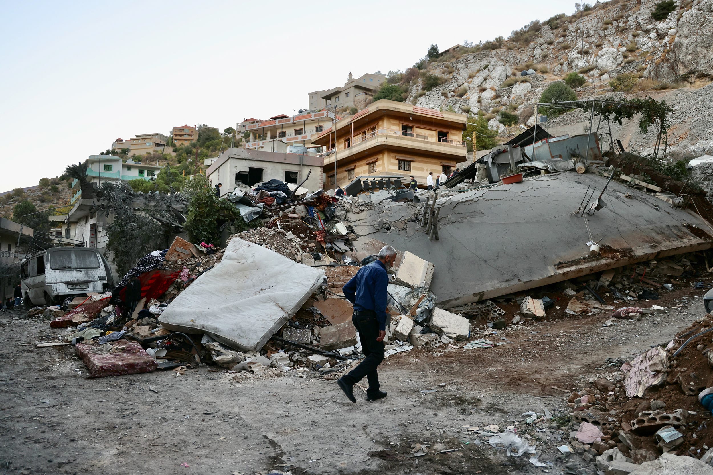 A man checks the destruction following an overnight Israeli airstrike in the southern Lebanese village of Shebaa near along the border between the two countries, on September 27, 2024.