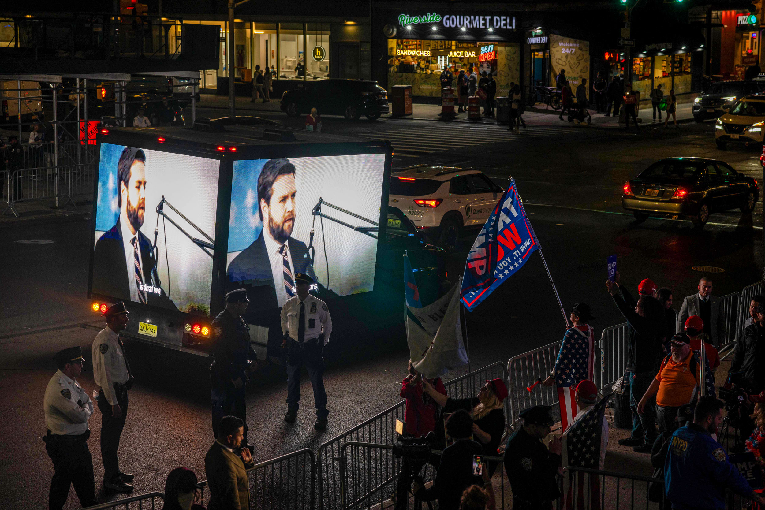 Demonstrators watch debate.