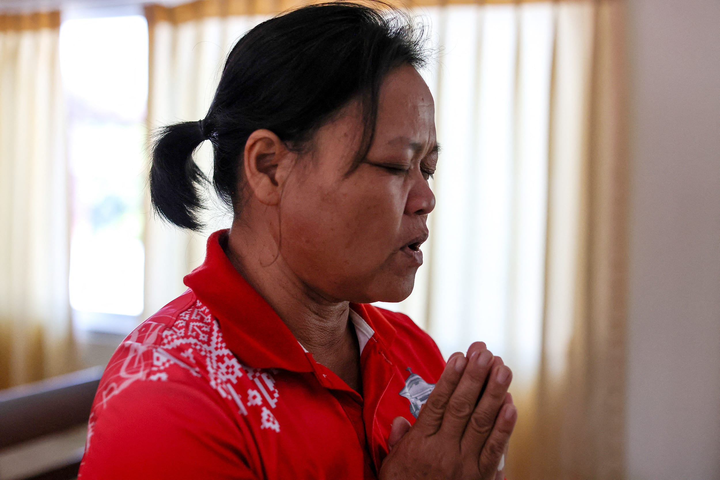 Wiwwaro Sriaoun, mother of a remaining Thai hostage captured by Hamas, Watchara Sriaoun, attends Sunday church service, in Kut Yang village, Udon Thani province