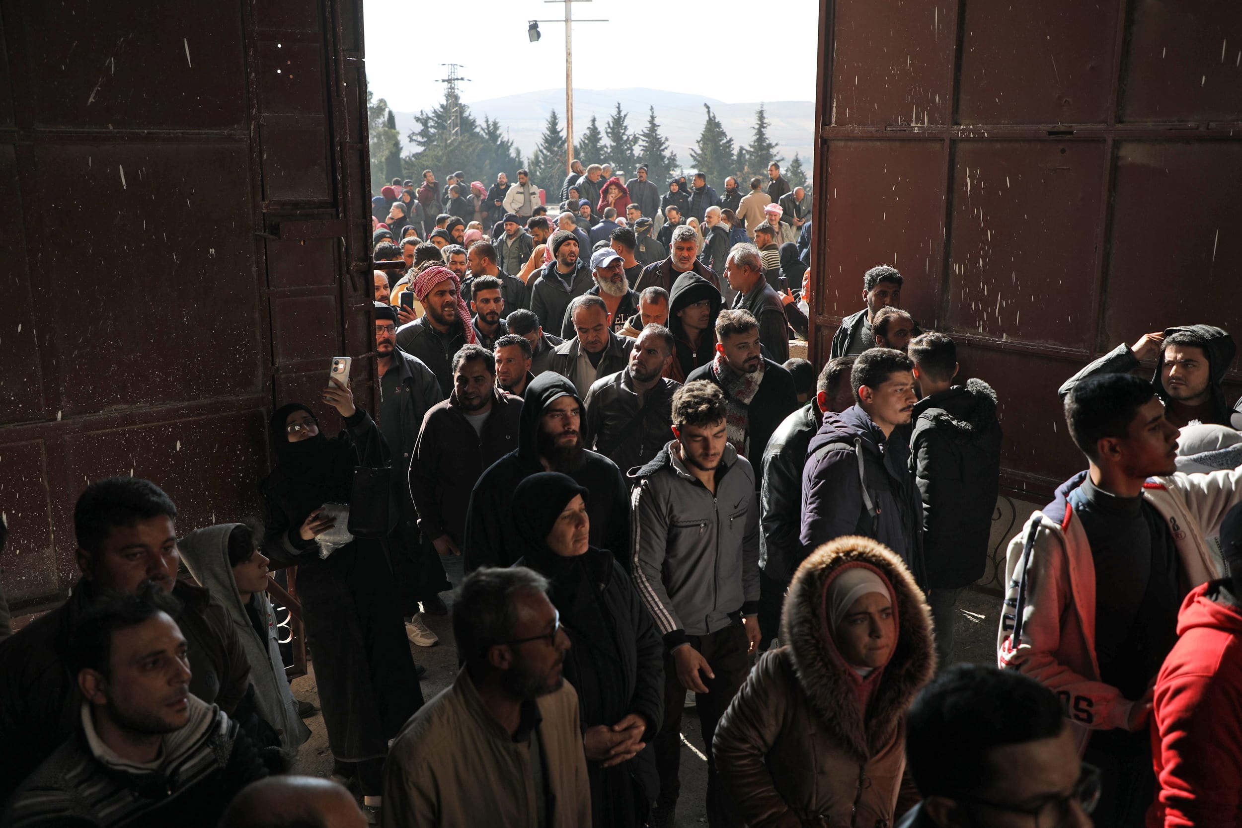 Crowds enter the gates at Saydnaya prison
