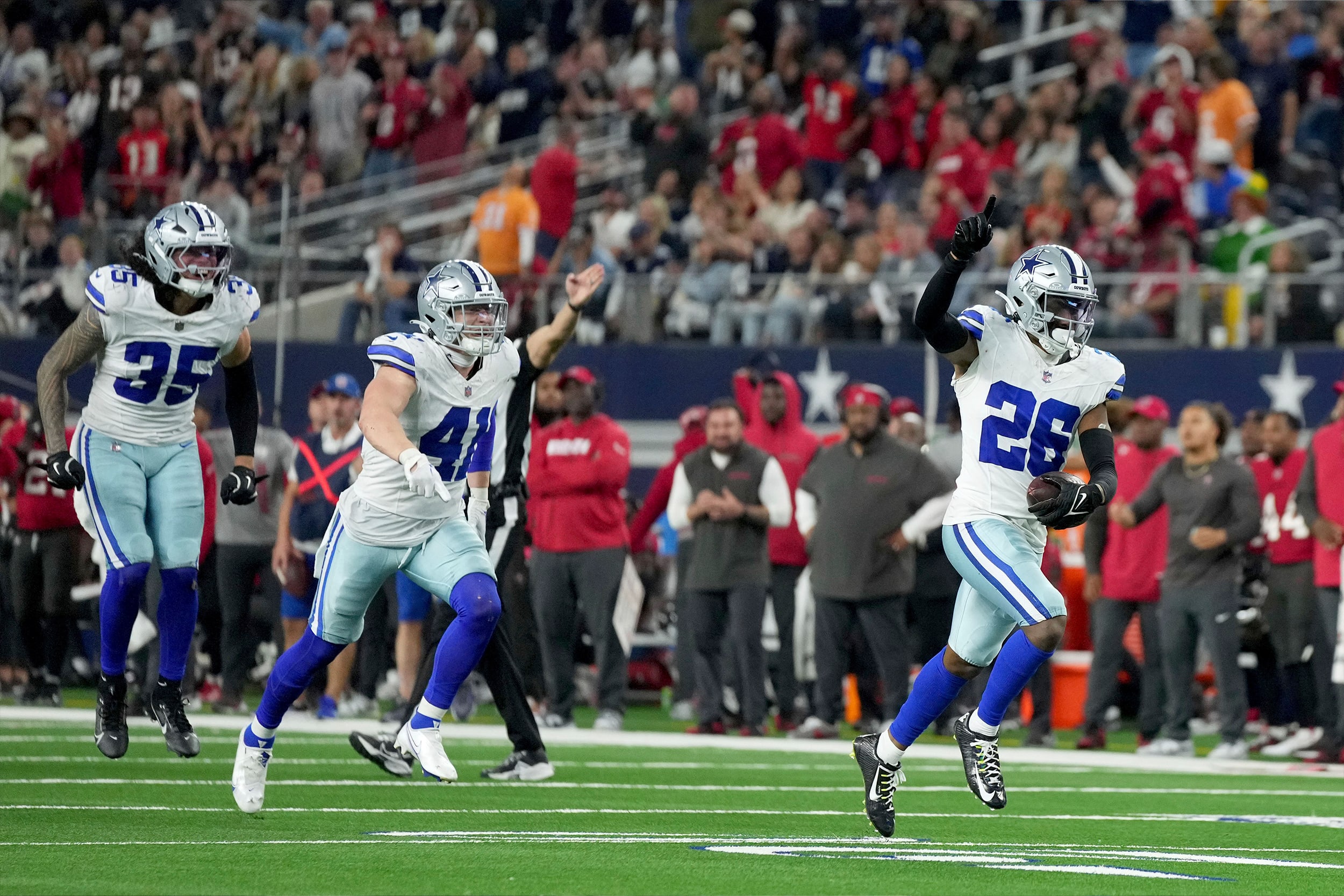 Dallas Cowboys cornerback DaRon Bland (26), Nick Vigil (41) and Marist Liufau (35) celebrate after Bland recovered a Tampa Bay Buccaneers fumble in the second half of a game in Arlington, Texas, on Sunday.