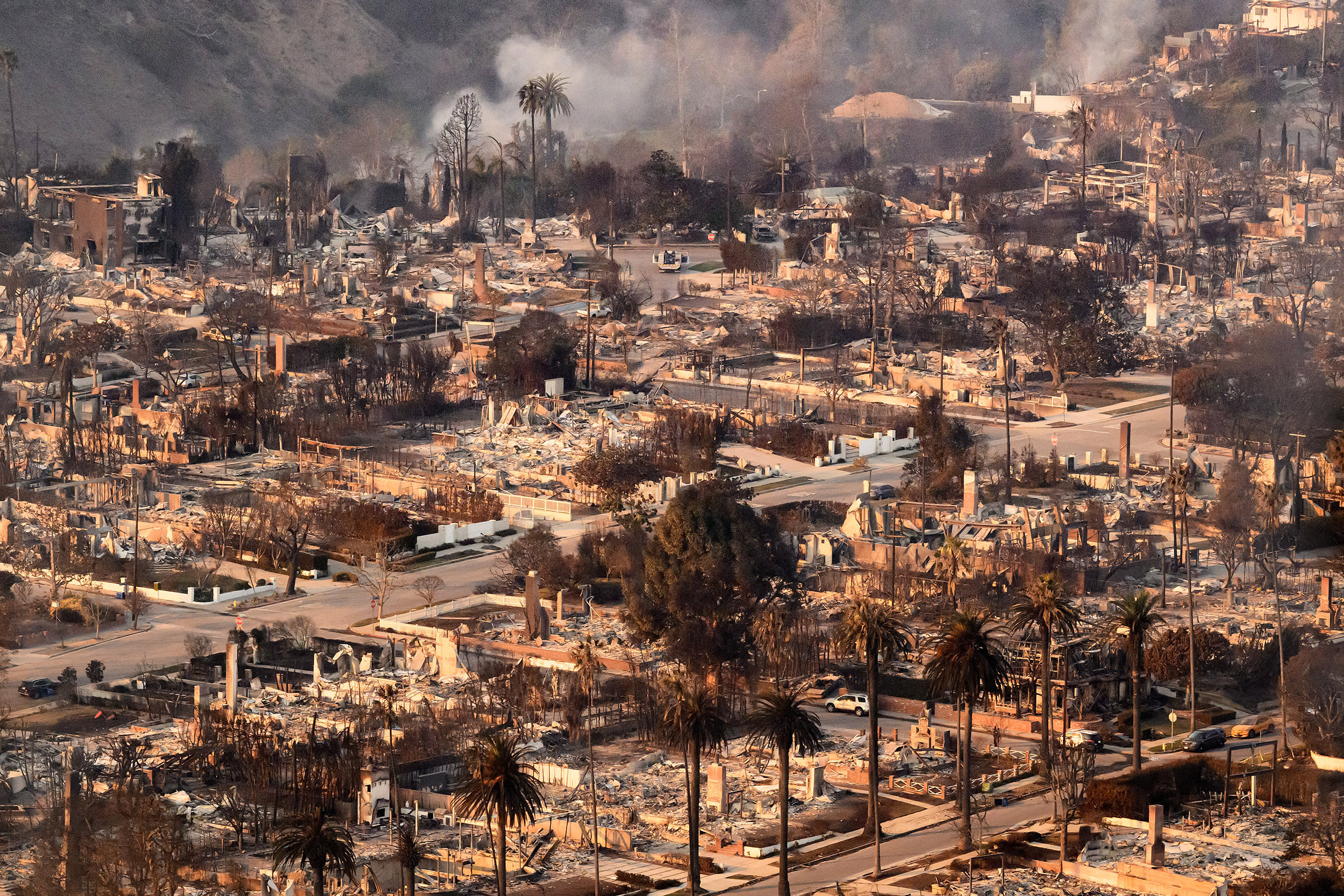 Image: aerial homes destroyed smoke smolder