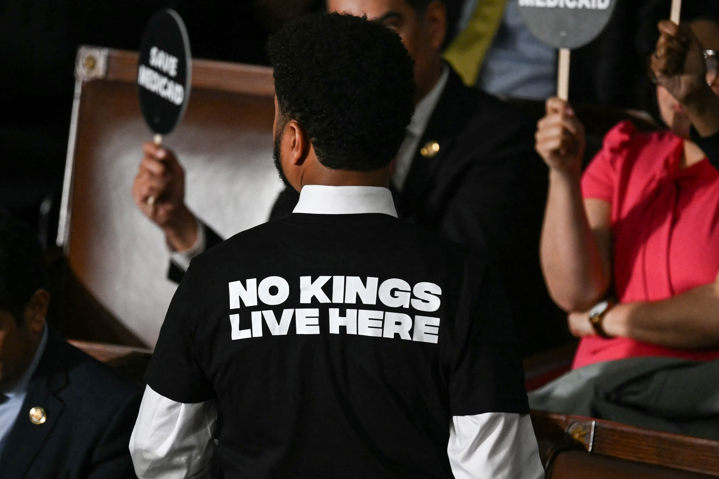 US Representative Maxwell Frost, Democrat from Florida, wears a shirt reading "No kings live here" as he walks out of the House Chamber while US President Donald Trump speaks during an address to a joint session of Congress at the US Capitol in Washington, DC, on March 4, 2025. 