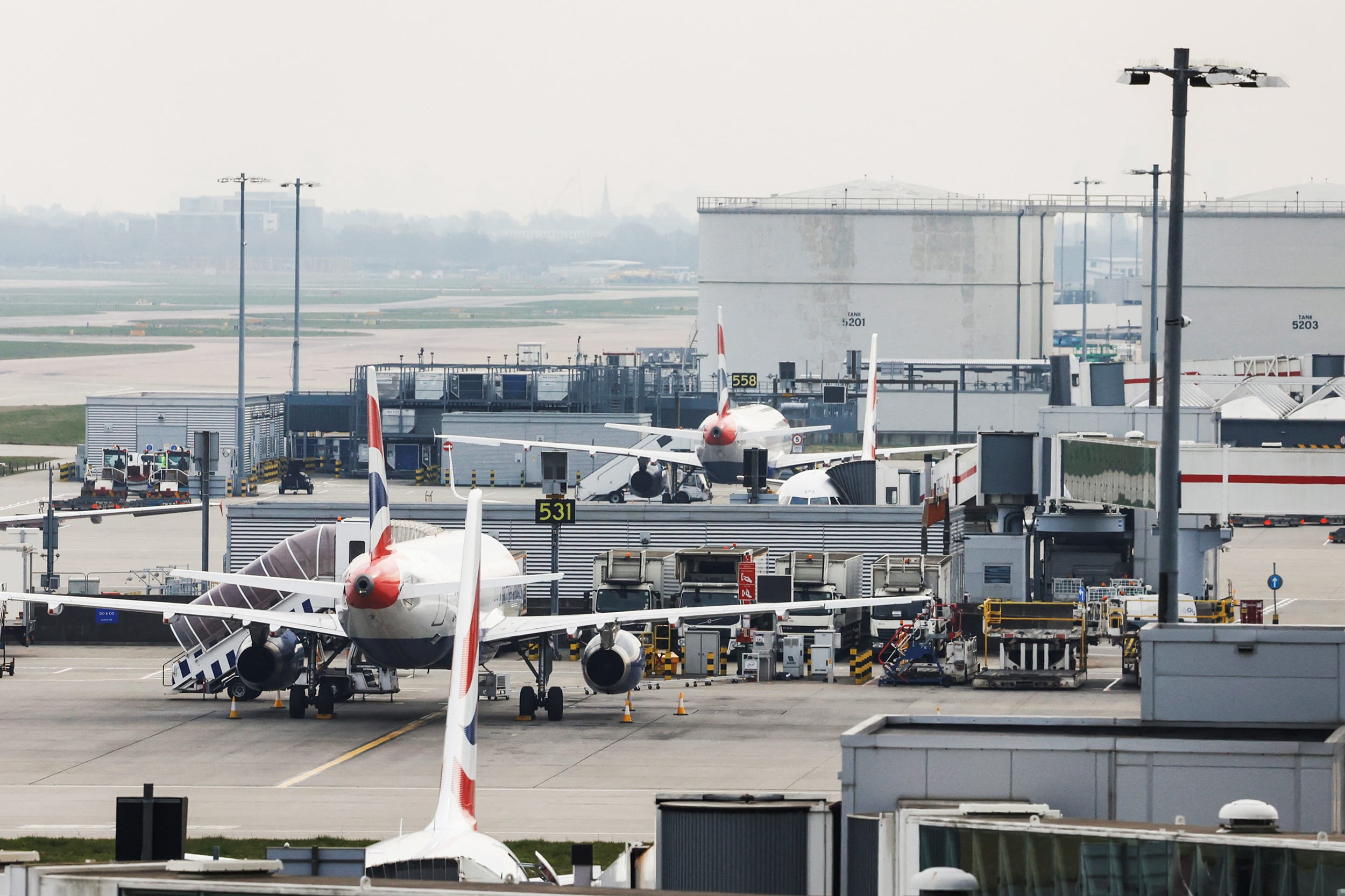 Airplanes remain parked on the tarmac at Heathrow International Airport after a fire at a nearby electrical substation on March 21, 2025.