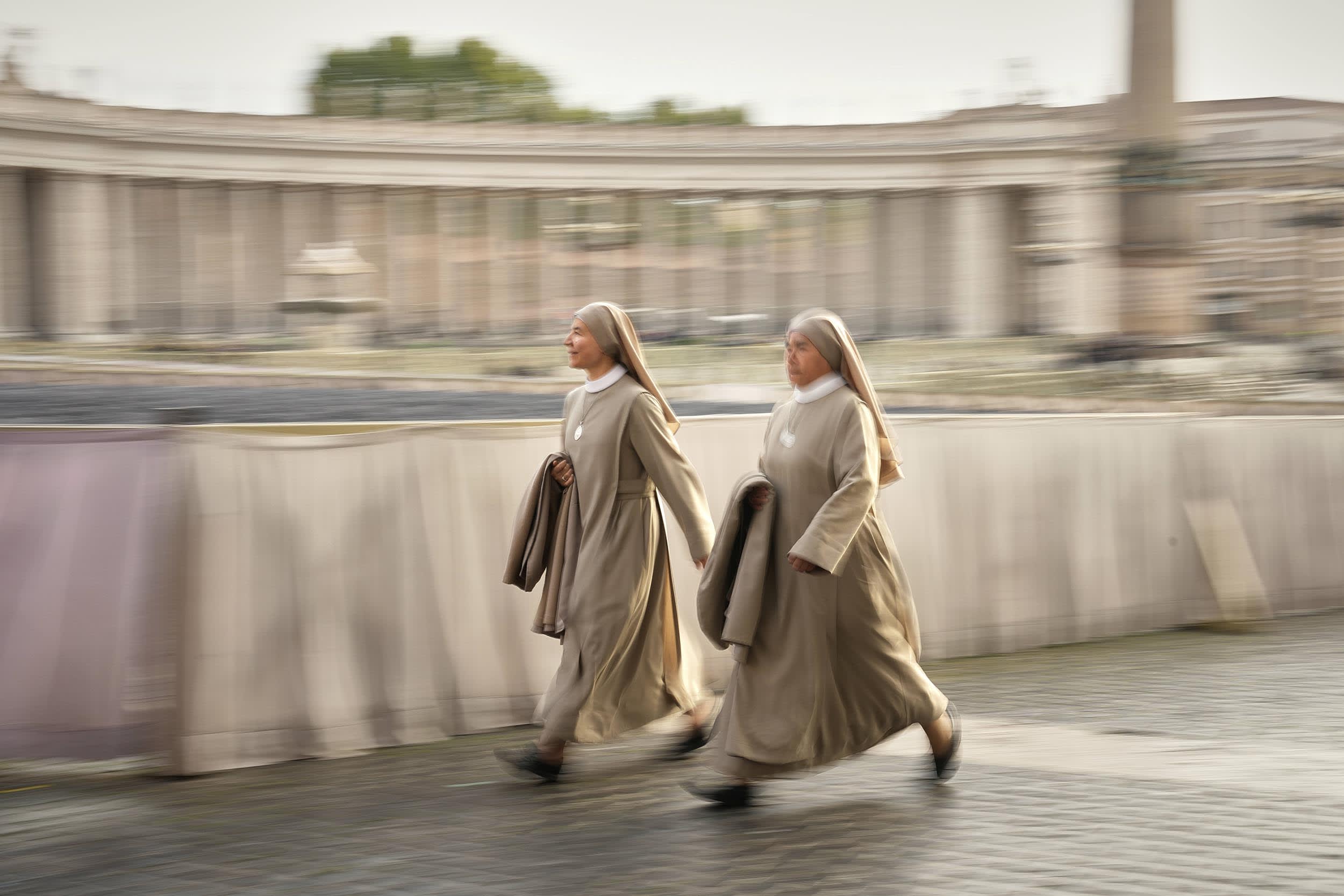 Nuns arrive in St. Peter's Square as they await the arrival of the body of Pope Francis, who will lie in state at St. Peter's Basilica for three days, at the Vatican, Wednesday, April 23, 2025. 