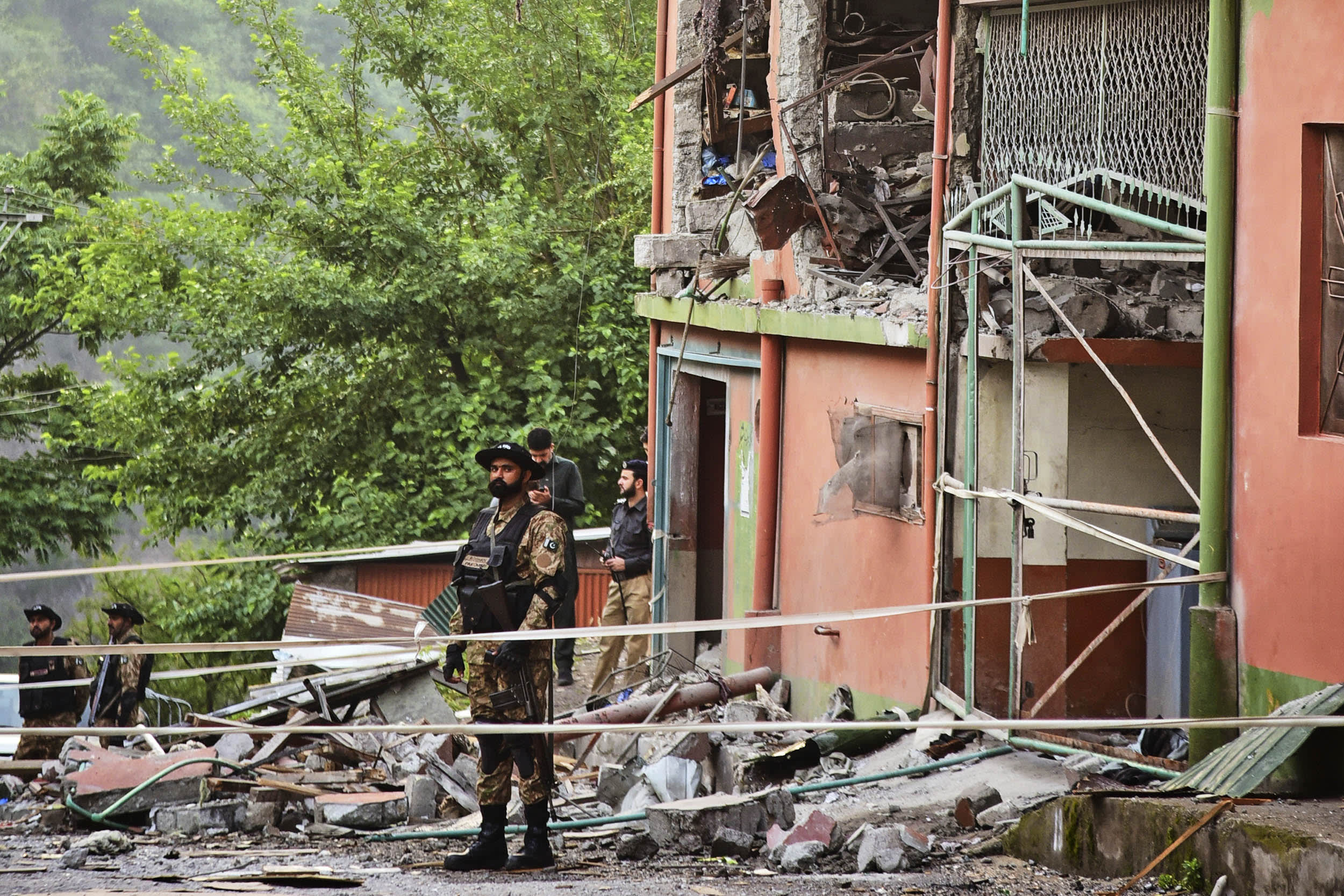 Army soldiers stand guard at a mosque building damaged by a suspected Indian missile attack near Muzaffarabad