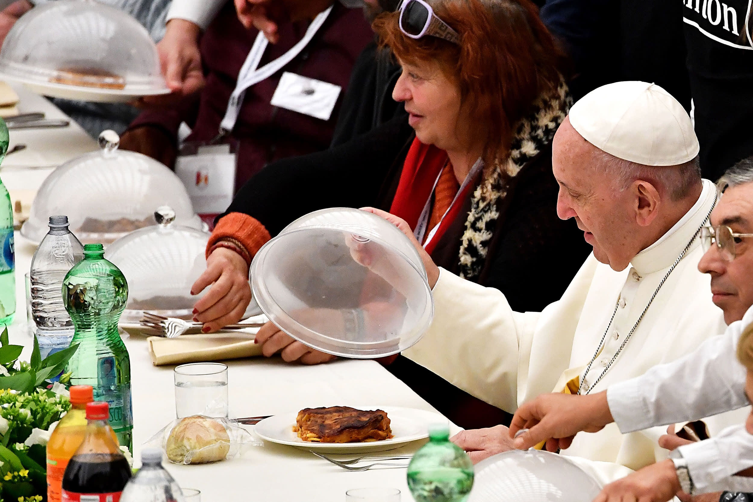 Pope Francis looks at his meal at the Paul VI audience hall in Vatican.
