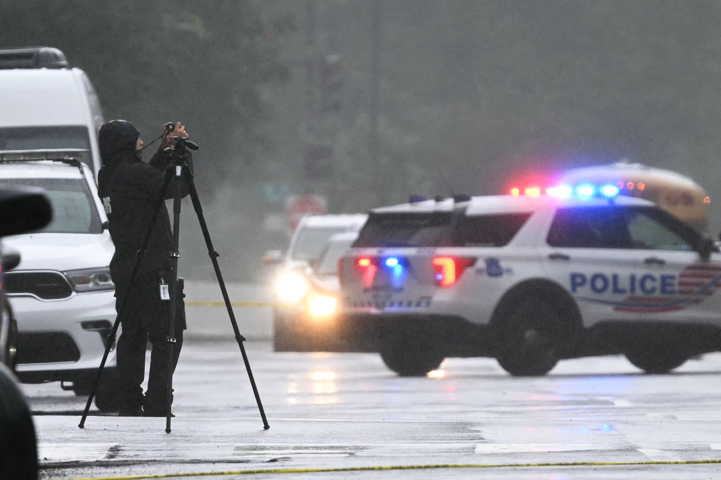 A forensics officer inestigates the shooting site outside the Capital Jewish Museum
