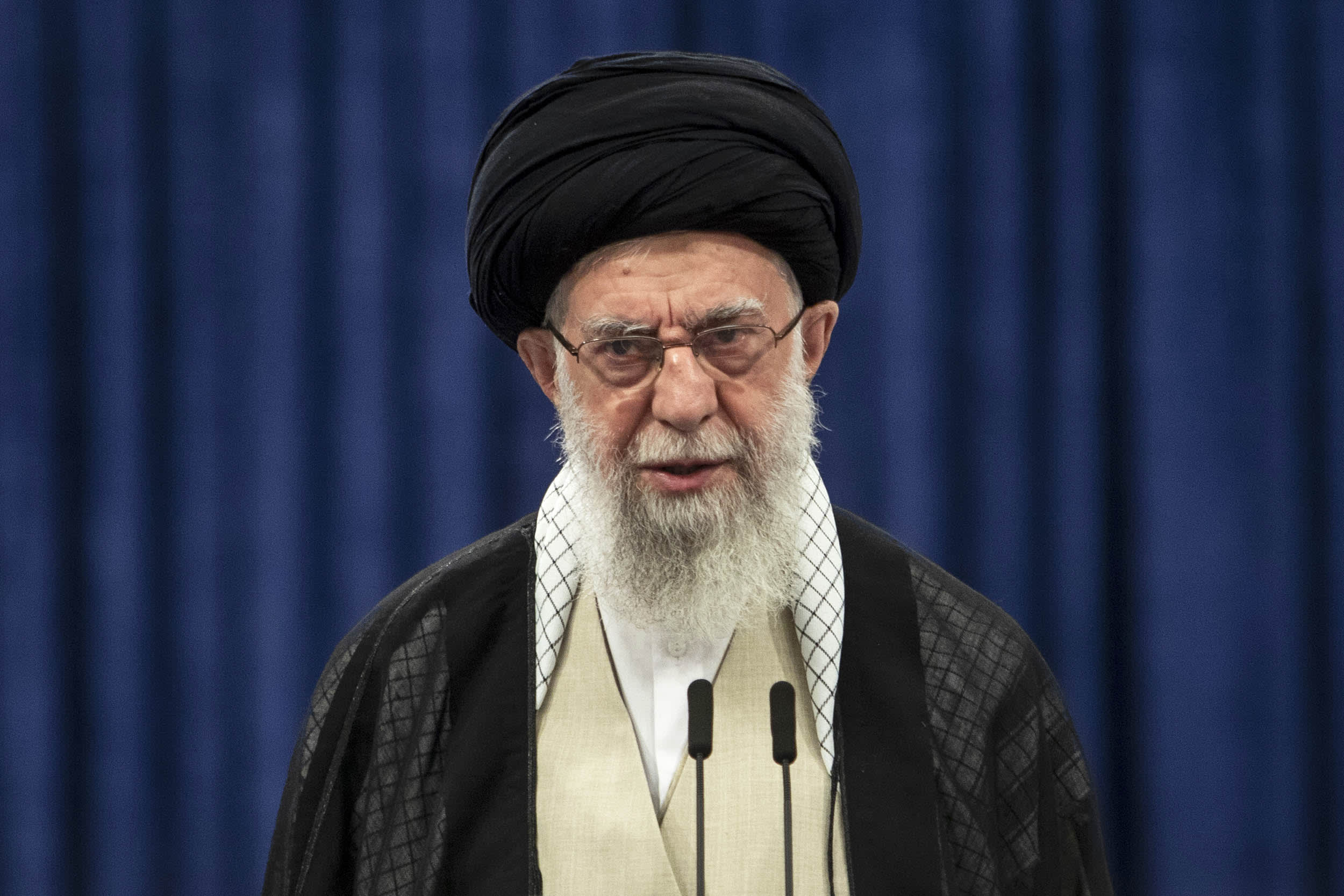 Iran's supreme leader Ayatollah Ali Khamenei speaking into a microphone