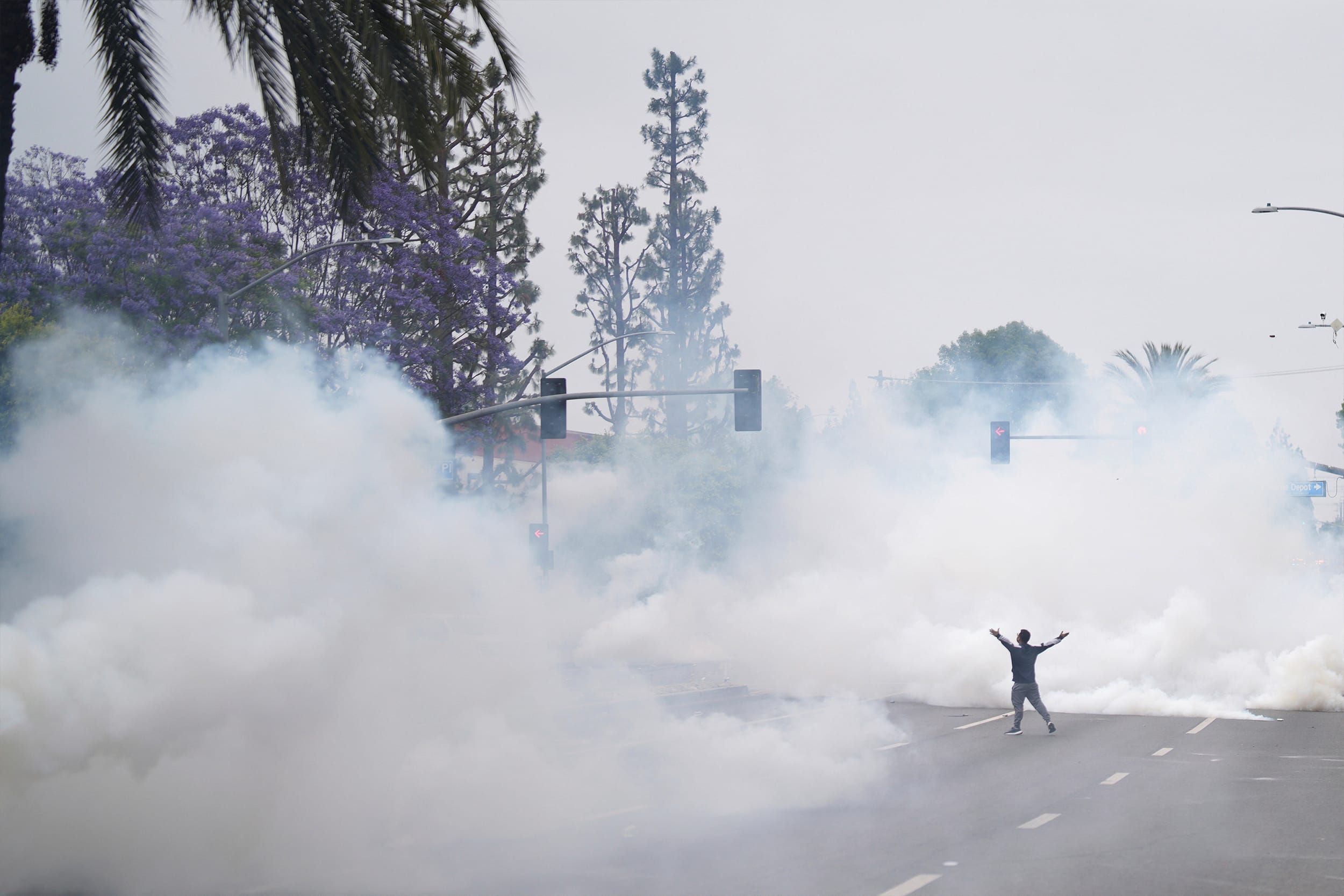 Tear gas fills the street as protesters confront Border Patrol personnel during a demonstration over the dozens detained in an operation by federal immigration authorities a day earlier in the city of Paramount, south of downtown Los Angeles, on Saturday, June 7, 2025.