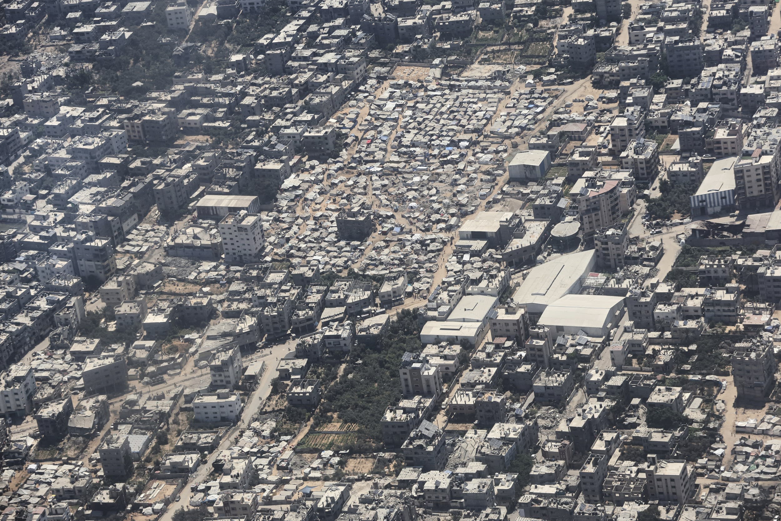 Image: A tent camp in Gaza City is seen from a Jordanian Air Force C-130 plane during an airdrop of humanitarian aid for Palestinians on the Gaza Strip, Thursday, Aug. 7, 2025.