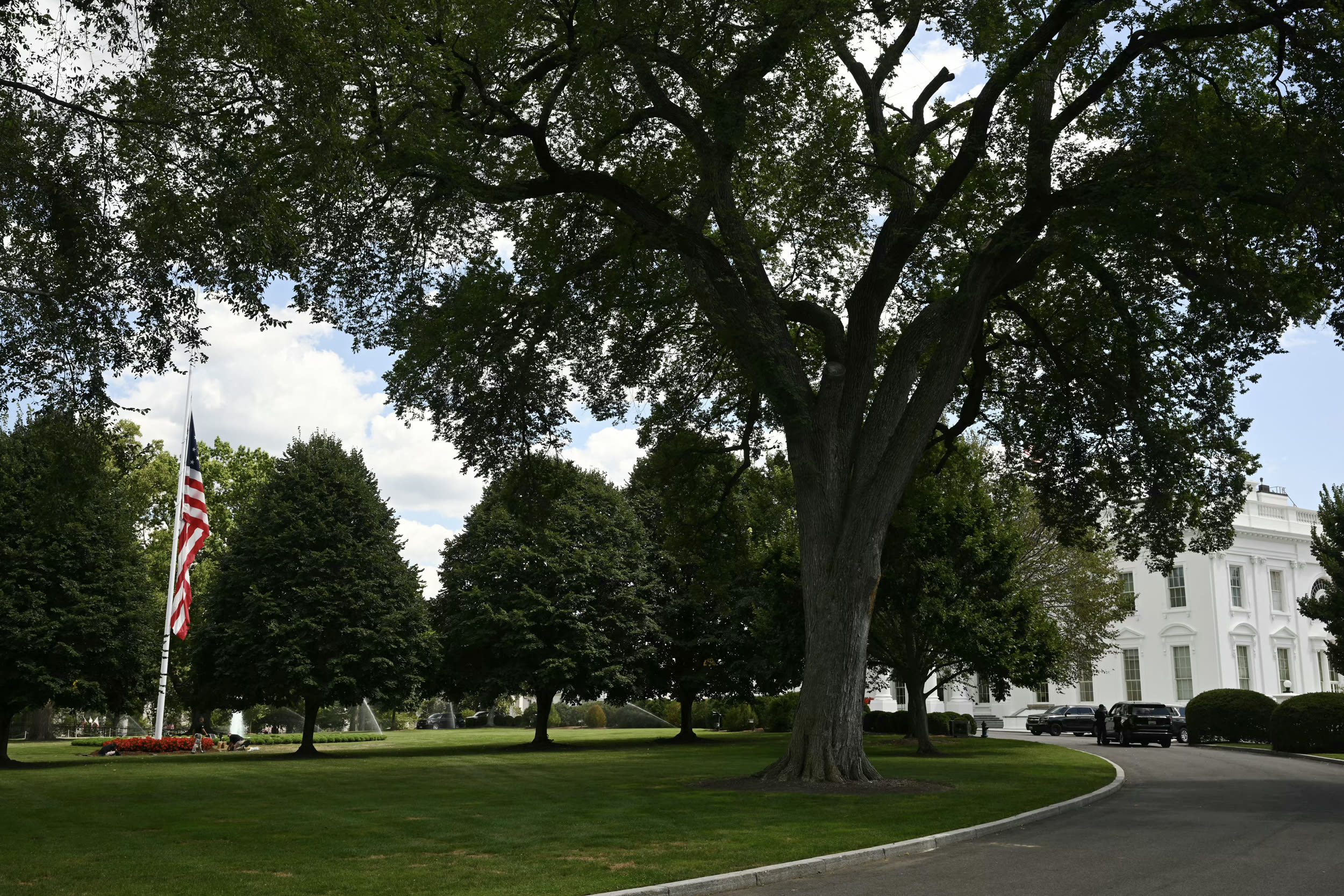 A large U.S. flag on the north lawn of the White House flies at half-staff on Aug. 27, 2025. 