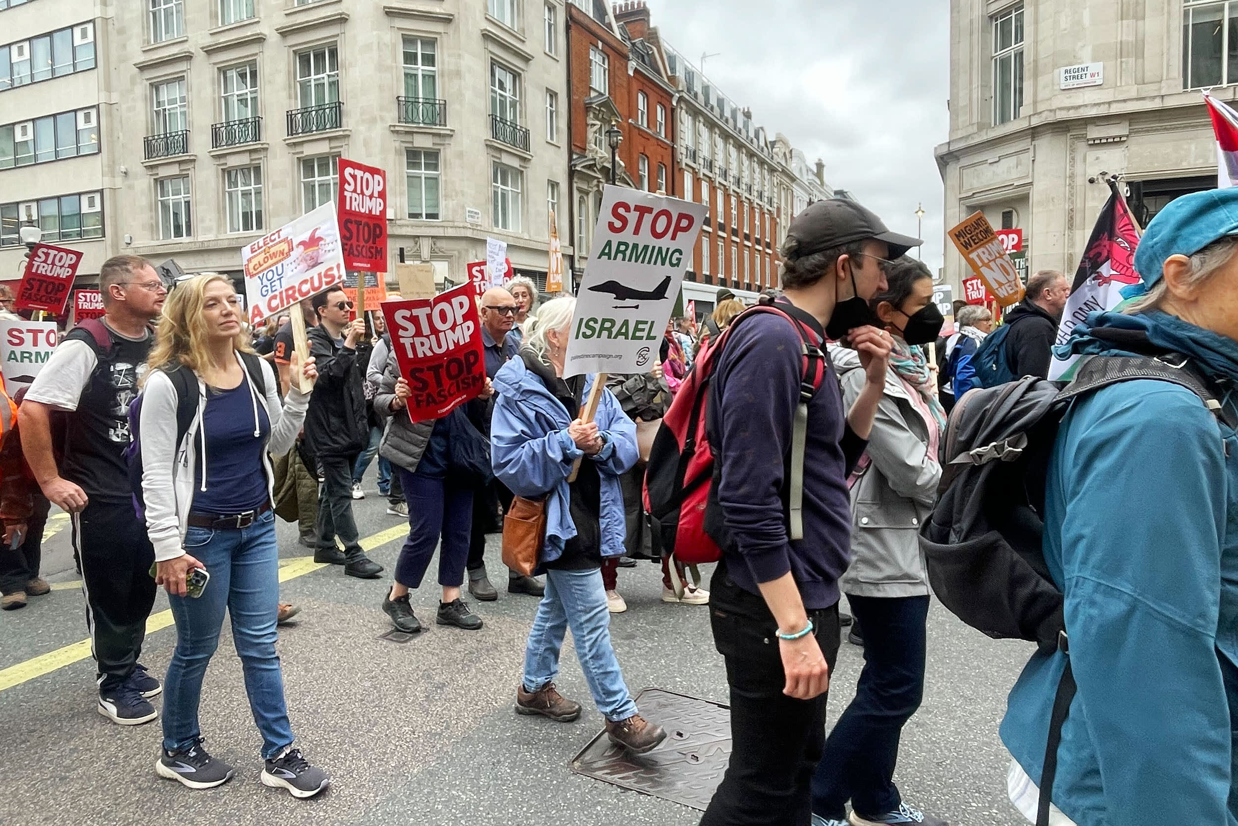 In a sea of anti-Trump protest signs, Palestinian flags and posters emblazoned with the words “end the genocide” also abound at the march in London rallying against the president’s state visit.