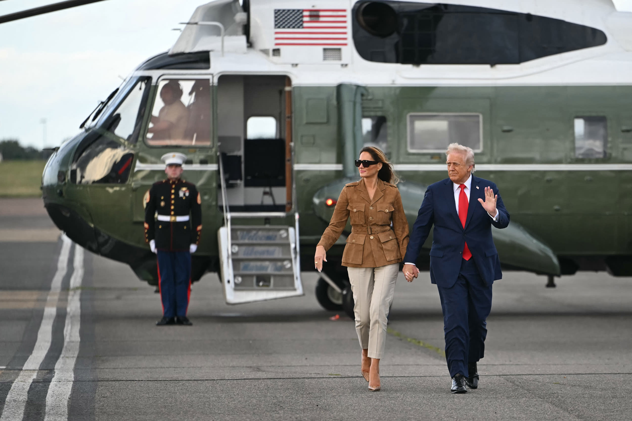 President Donald Trump and first lady Melania Trump walk across the tarmac from the Marine One helicopter toward Air Force One at Stansted Airport, in Stansted, north of London, on September 18, 2025.