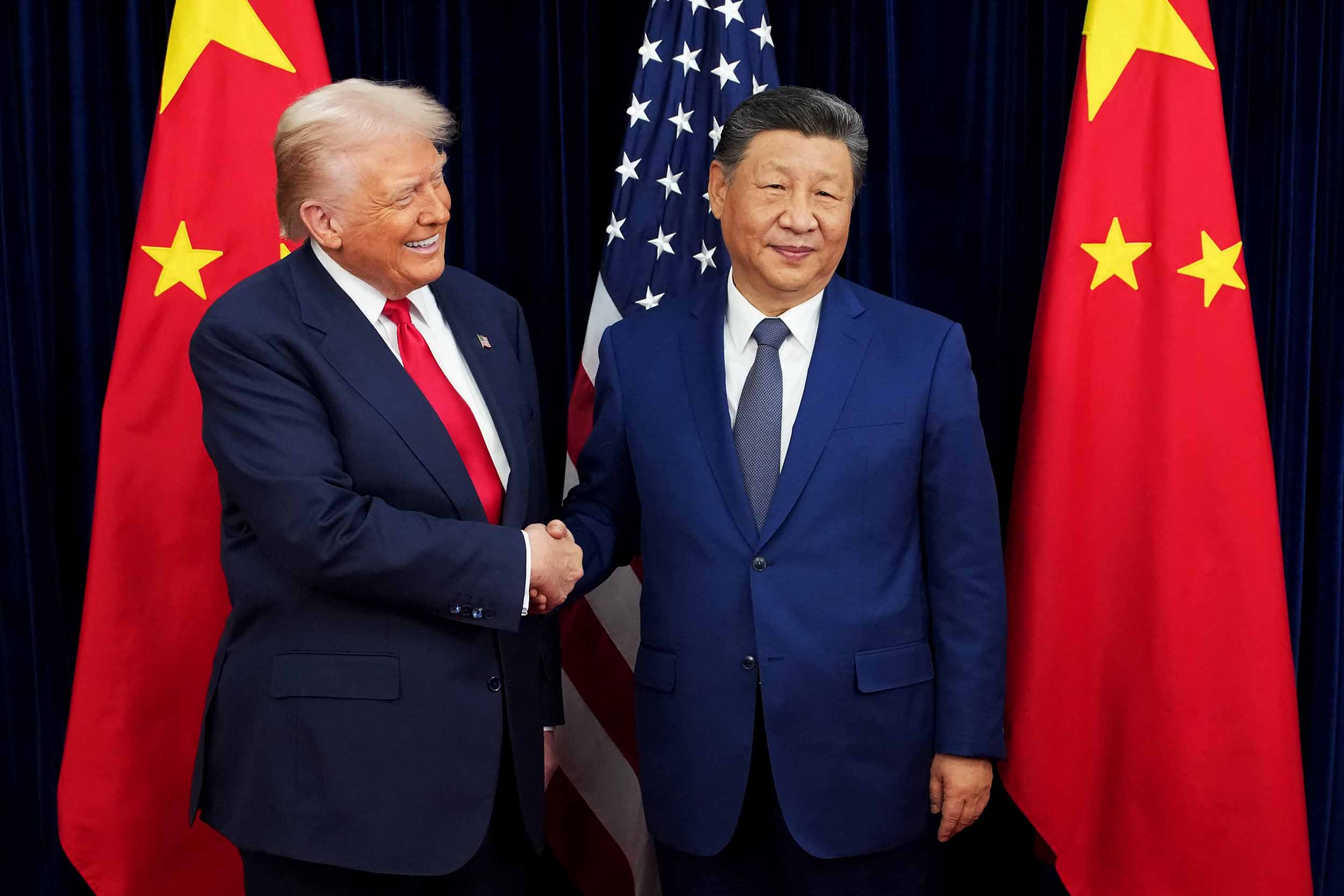 President Donald Trump greets Chinese President Xi Jinping ahead of a bilateral meeting at Gimhae Air Base on Thursday.