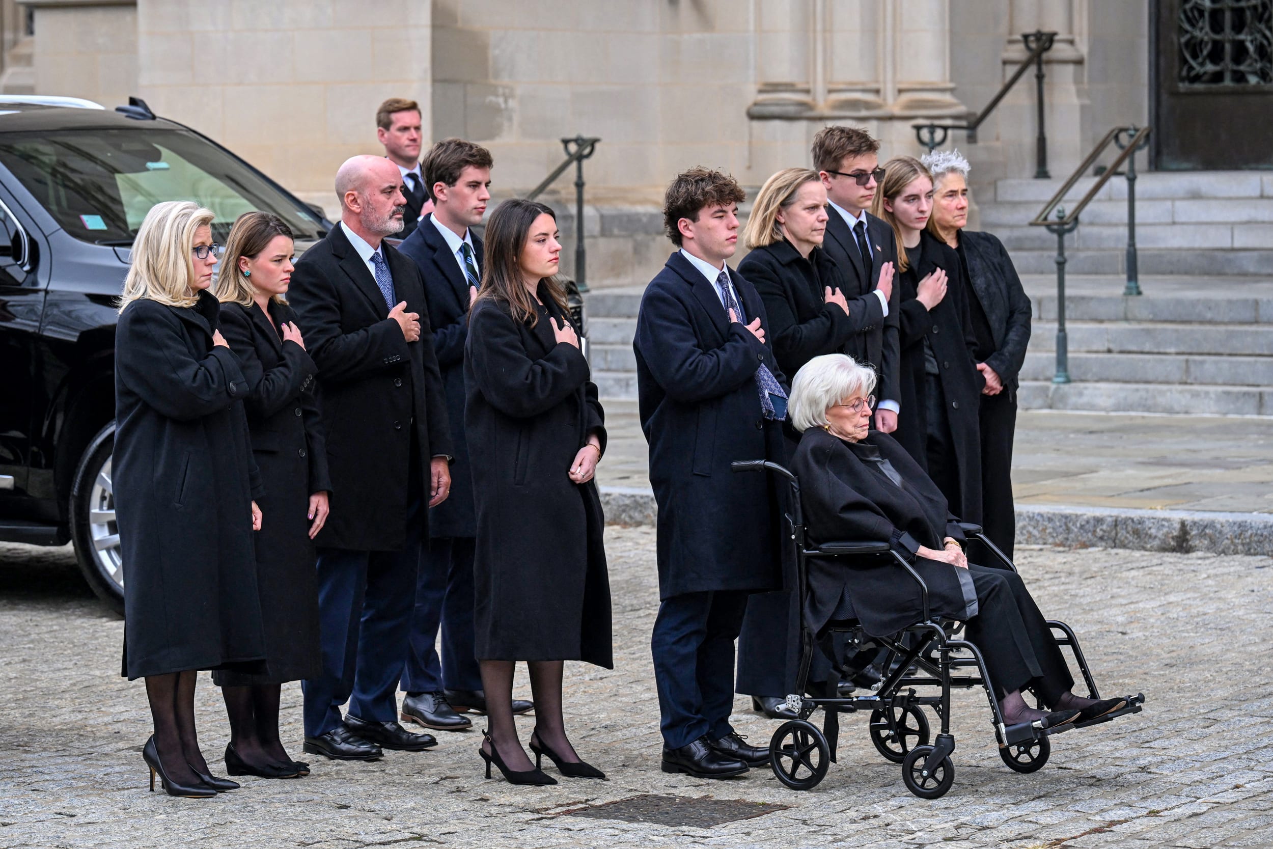 Former Congresswoman Liz Cheney stands with family members.