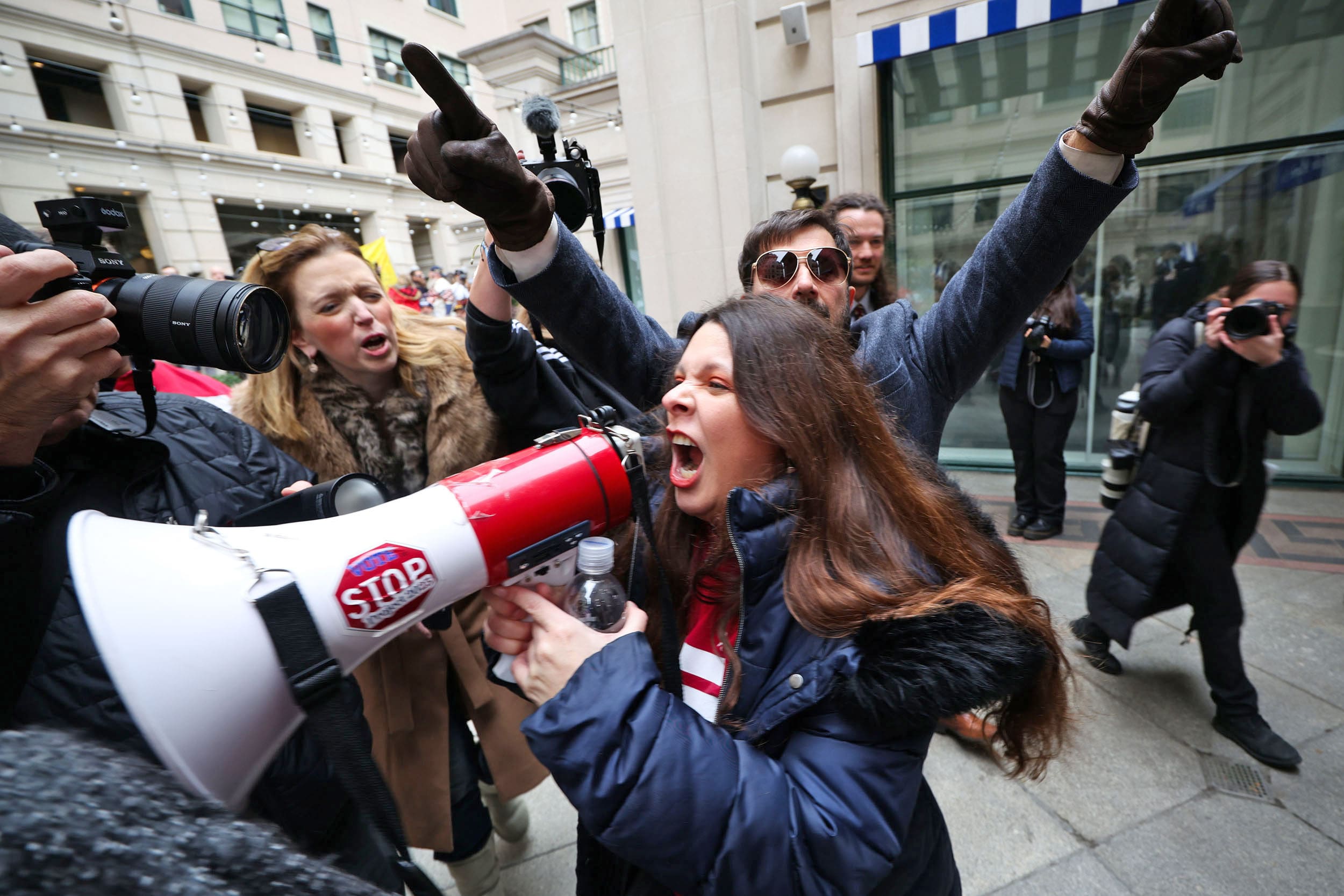 Counter-protester Patricia Eguino, center, clashes with demonstrators during a January 6th memorial march marking five years since the attack.