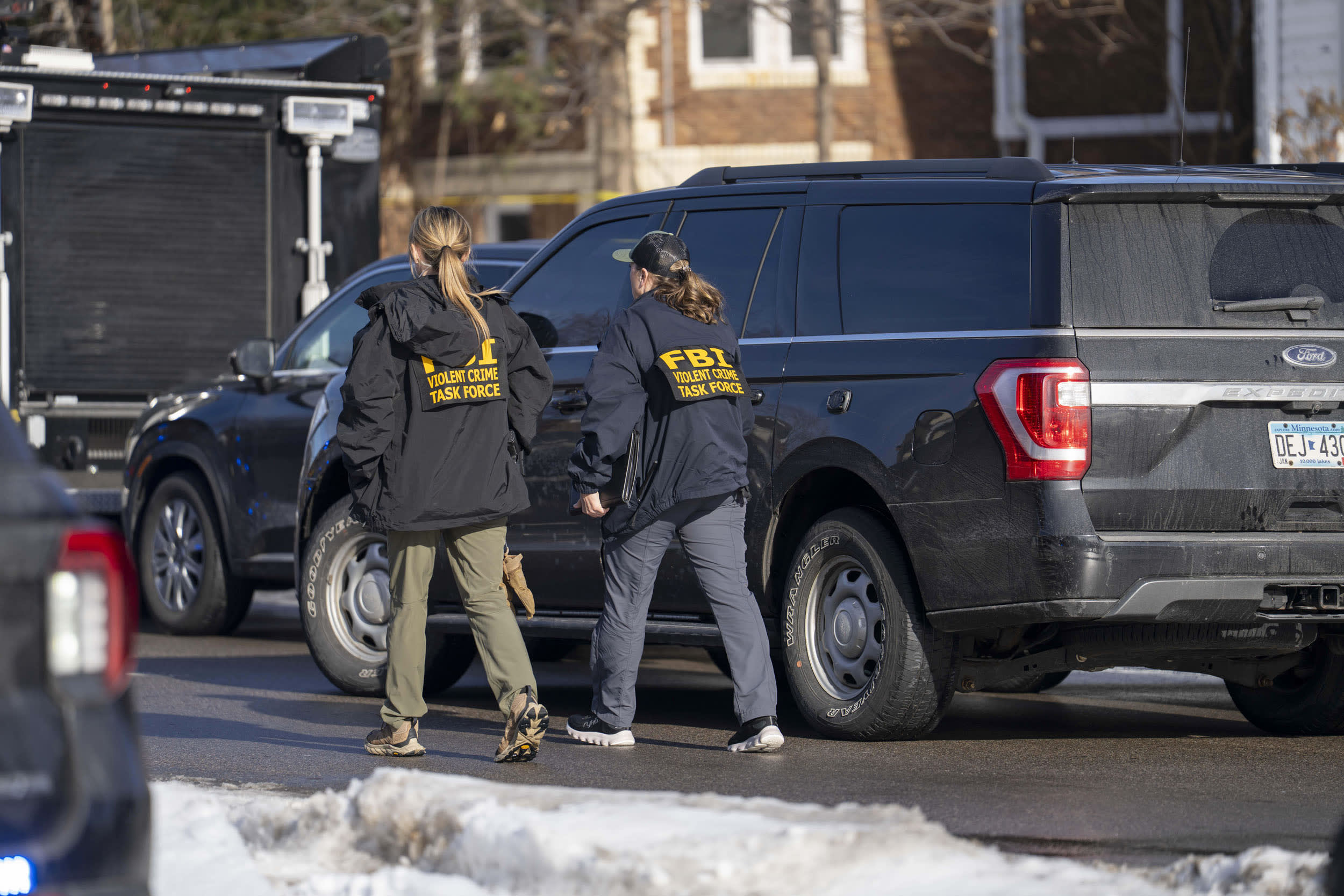 FBI agents at the scene where a woman was fatally shot by an ICE officer in Minneapolis on Jan. 7, 2026. A