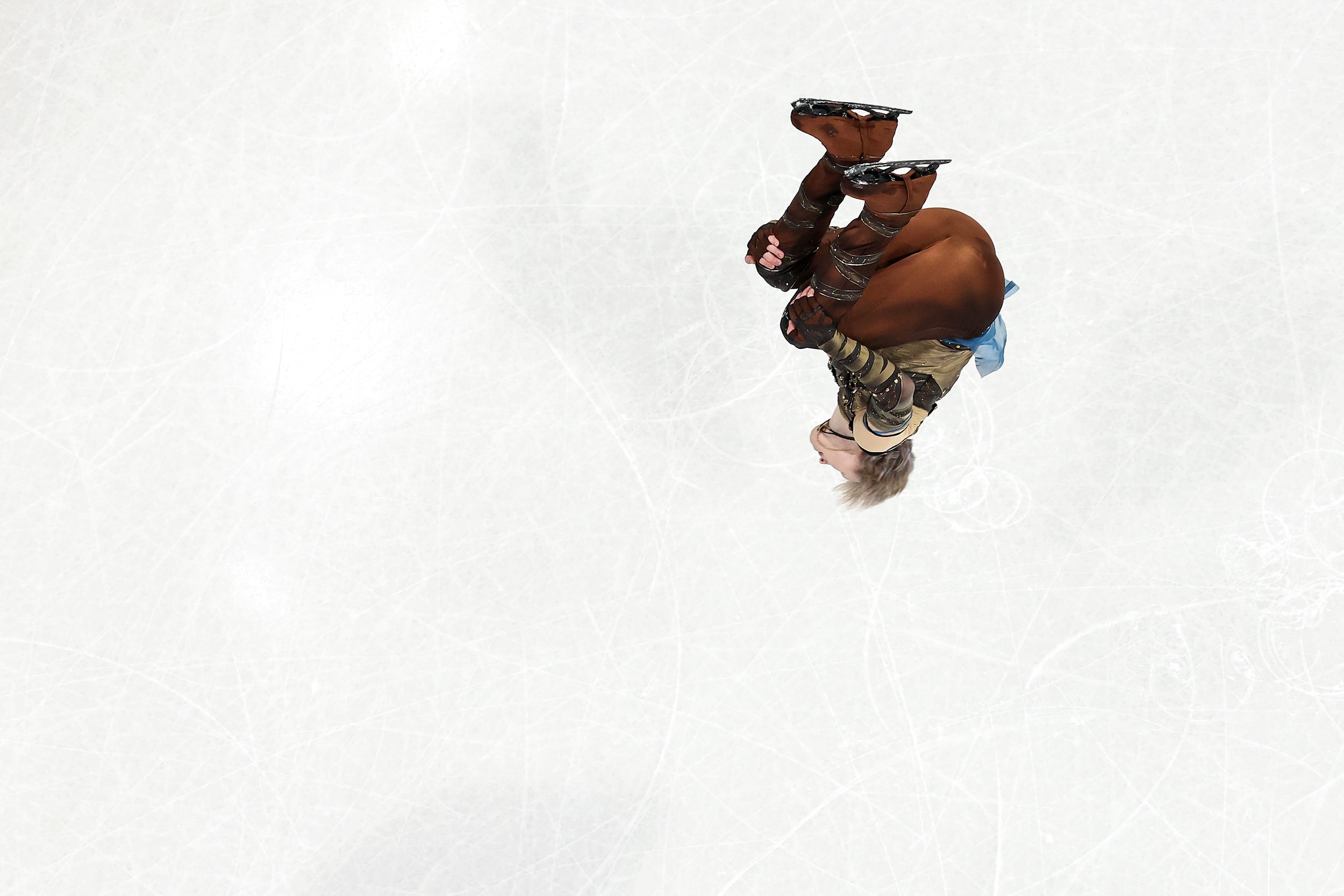 Ilia Malinin does a backflip while skating on the ice. 