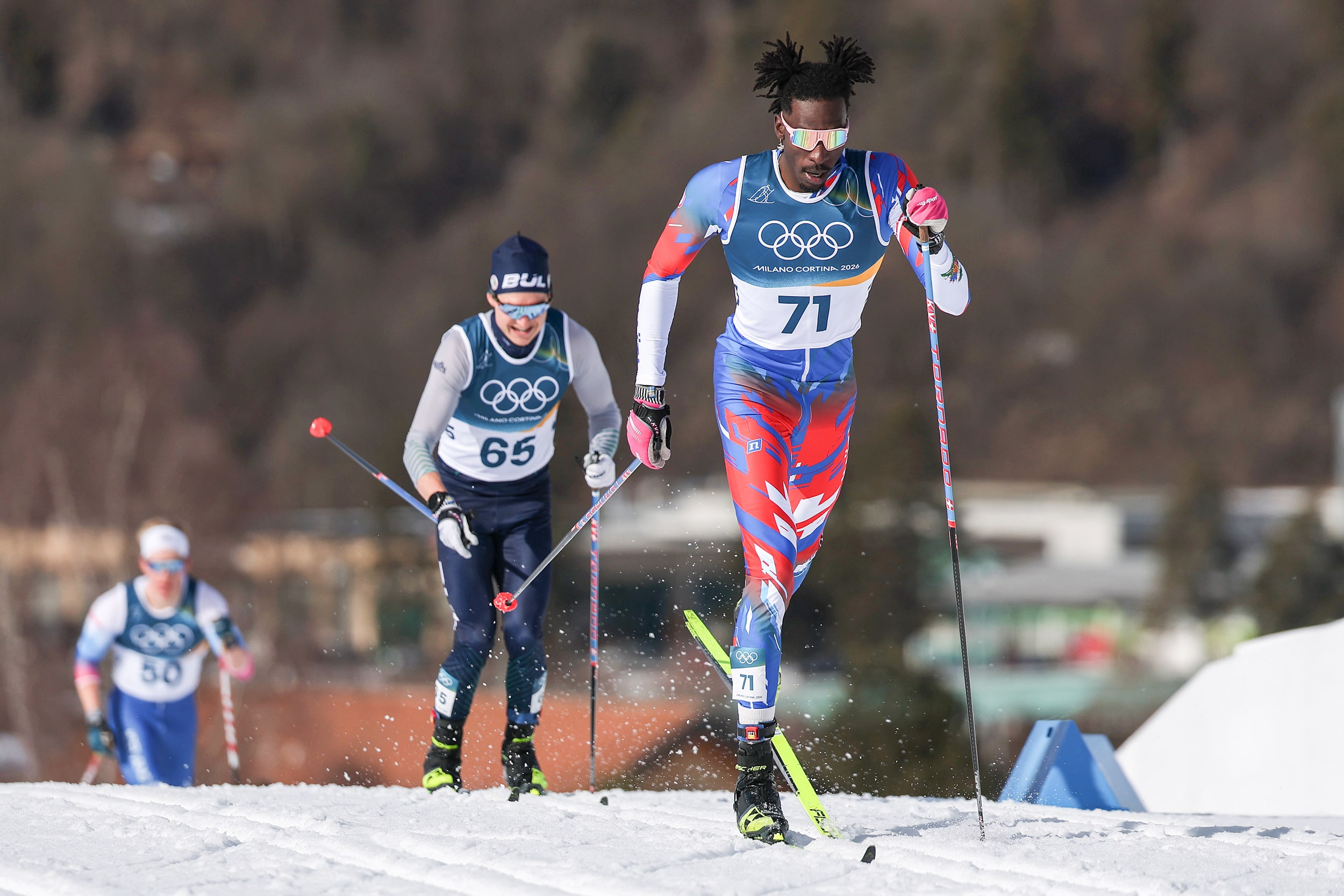 Stevenson Savart pulls with his ski poles during a winter olympic event.