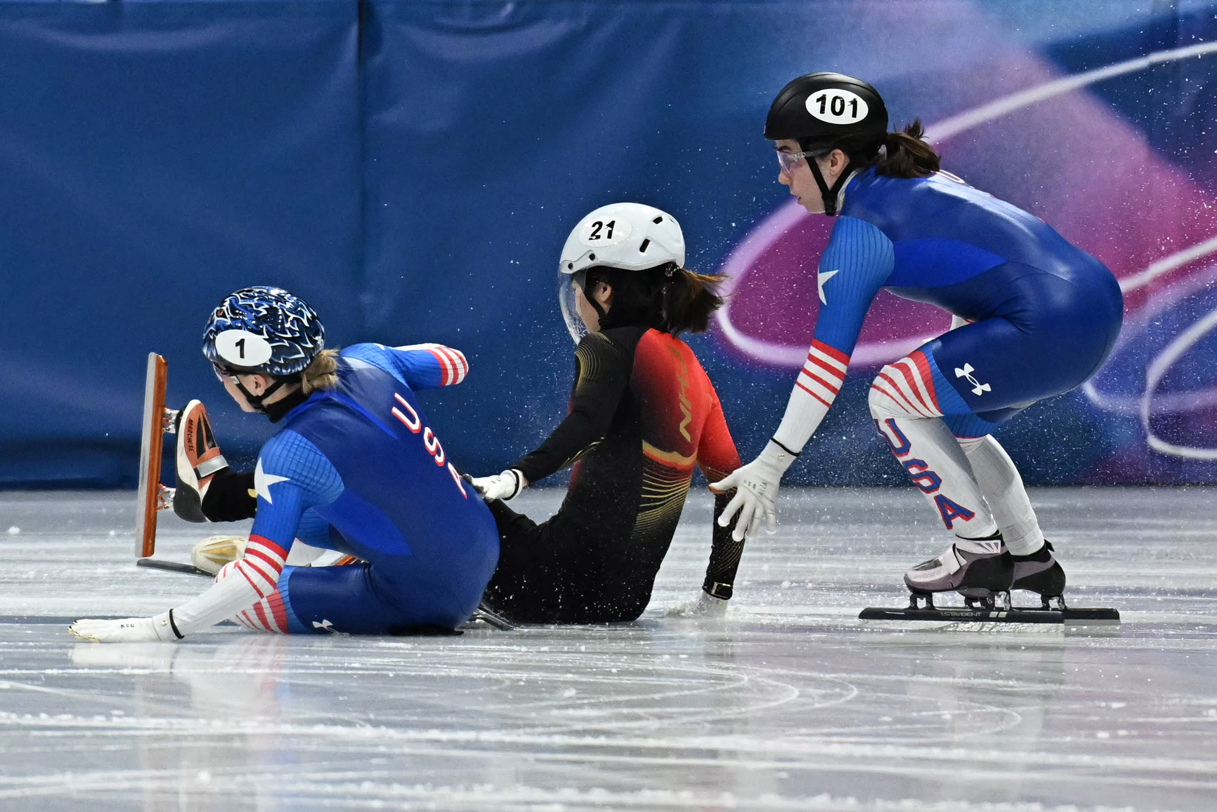 Kristen Santos-Griswold of Team United States and Chutong Zhang of Team China fall in the short track speed skating women's 500m quarter-final