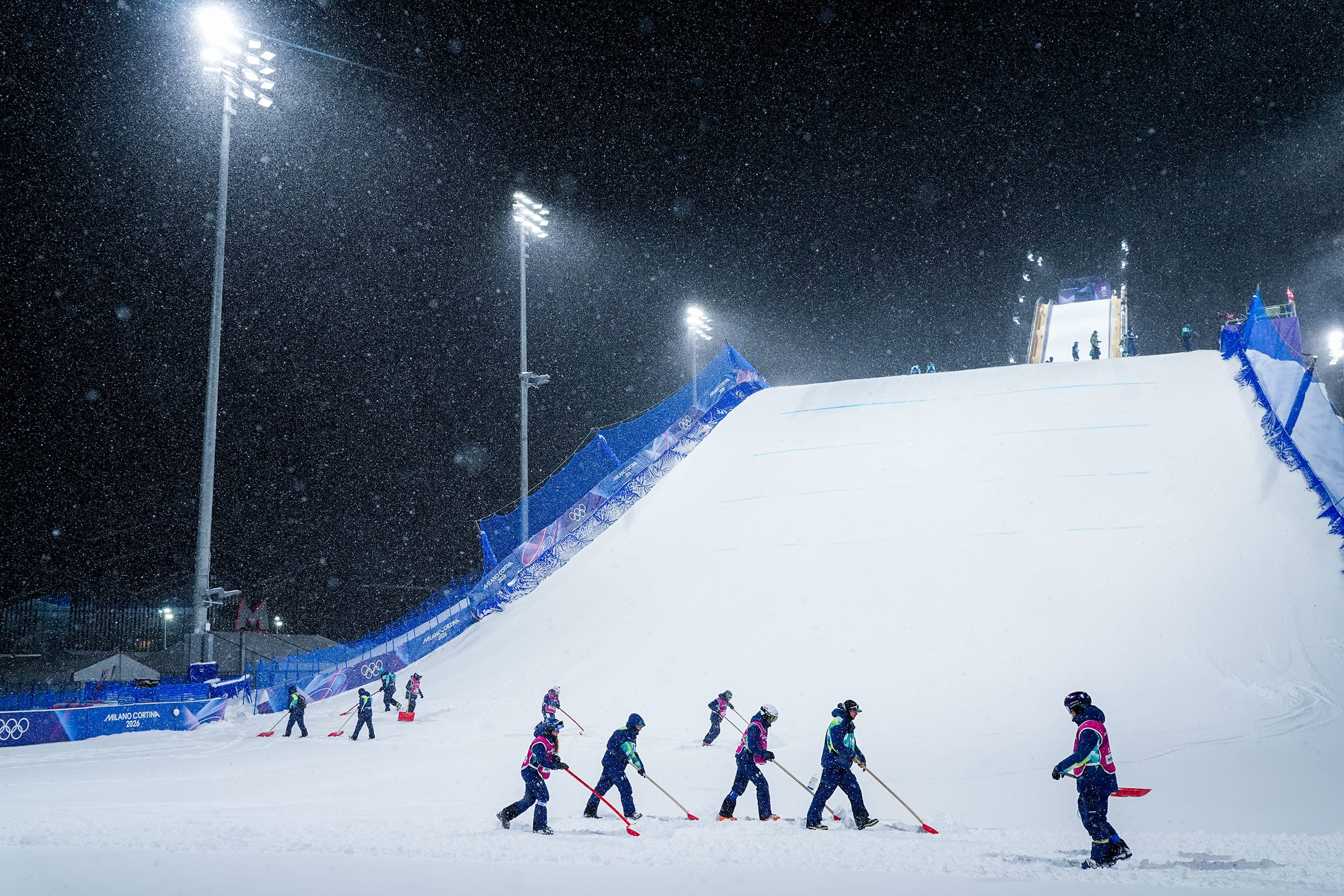 Course workers on the slopes as a blizzard delays proceedings before the Freestyle Skiing Women's Freeski Big Air Final.