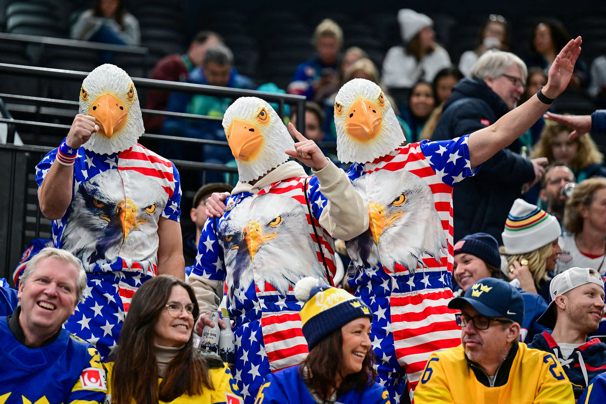 USA's supporters cheer wearing eagles masks.