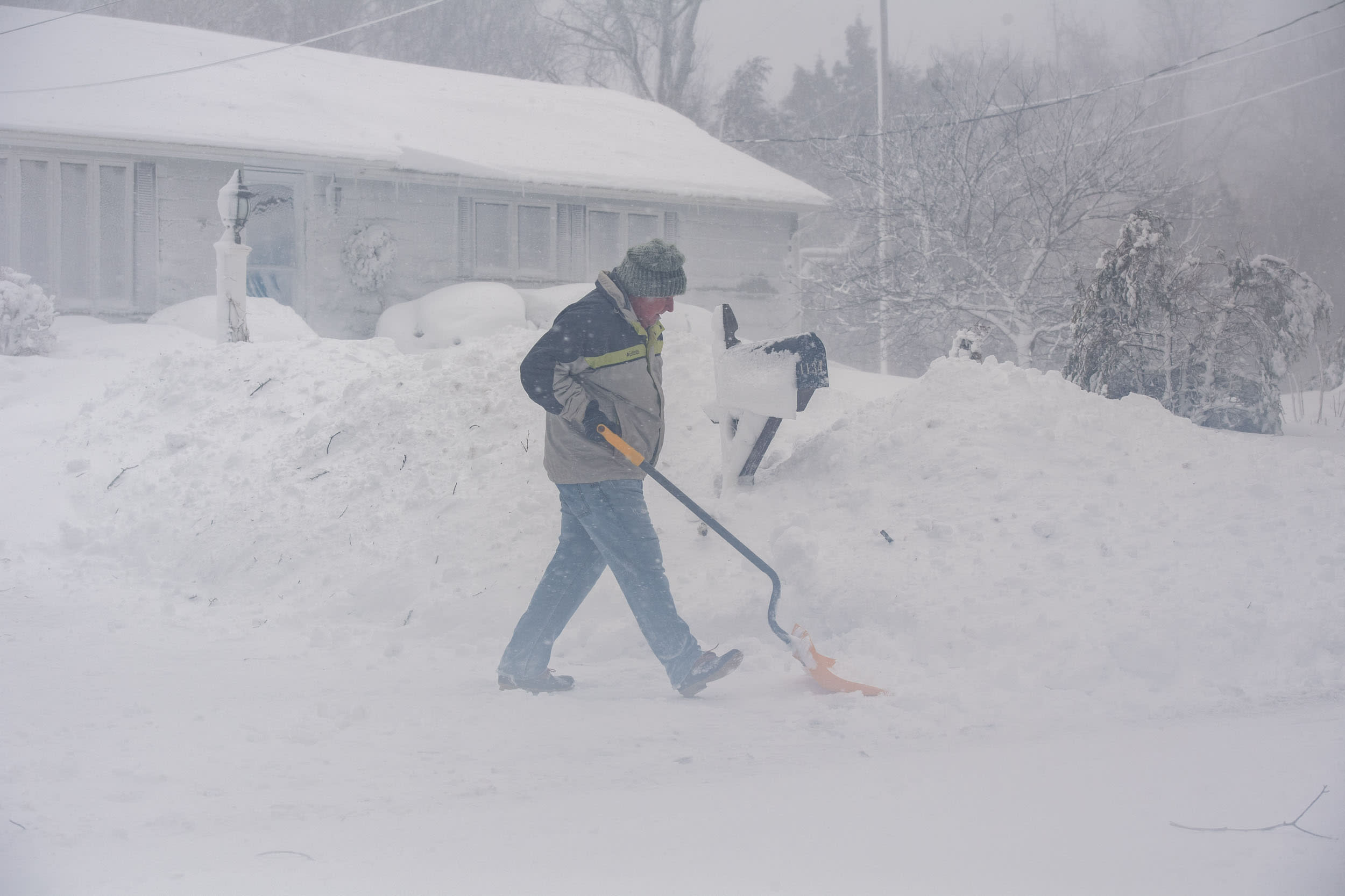 A man shovels a driveway in Norwell, Mass