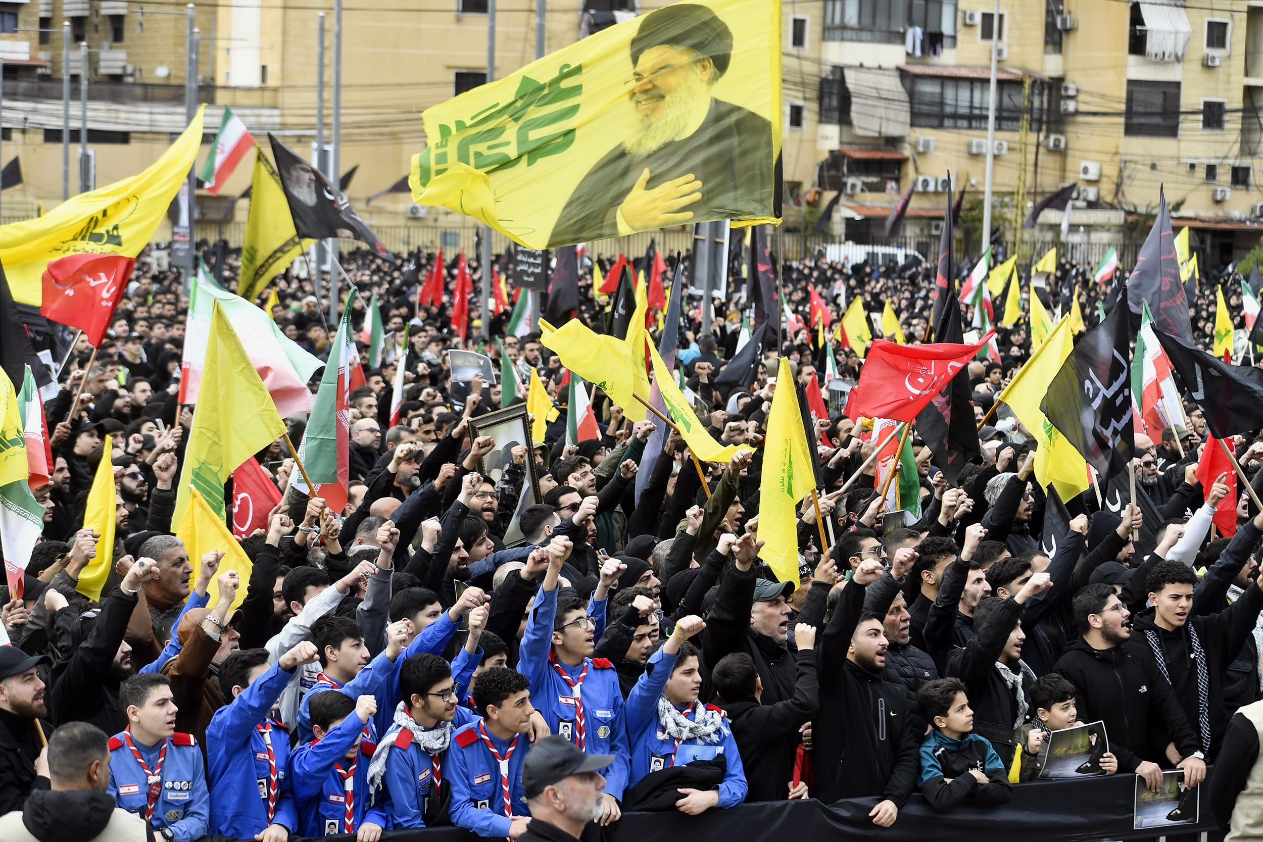 Thousands of people gathered in a central area of Beirut waving Hezbollah flags and raising their fists in the air