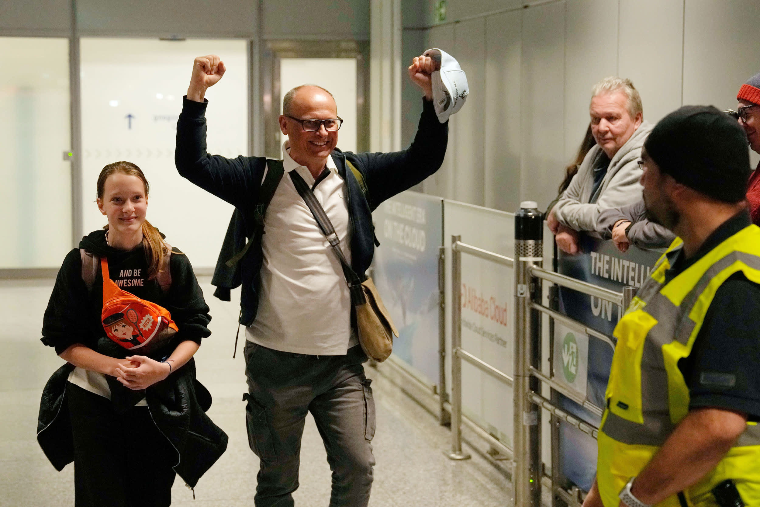 A man celebrates as he arrives at the International Airport in Frankfurt, Germany, after being evacuated from Dubai on a commercial flight, Tuesday, March 3, 2026.