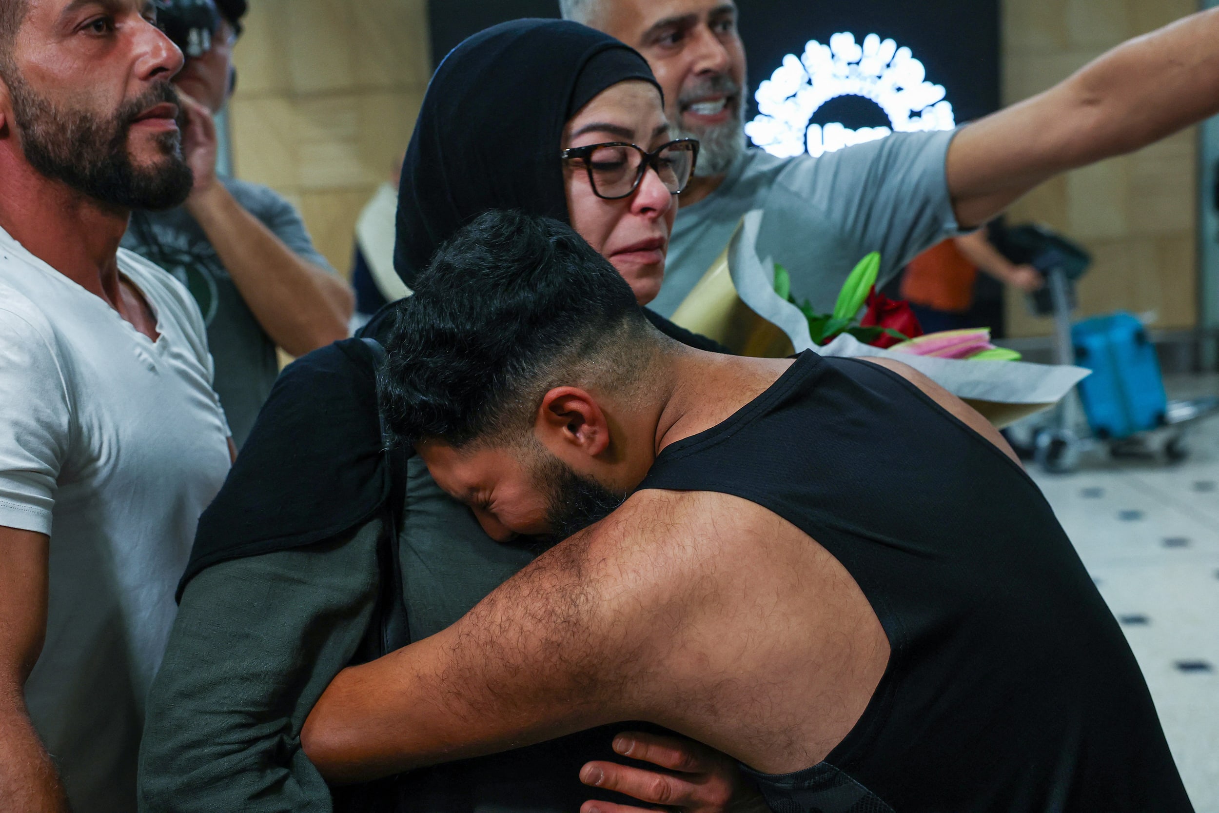 A passenger reacts after disembarking from a Emirates flight coming from Dubai at Sydney Kingsford Smith International Airport on March 4, 2026. 