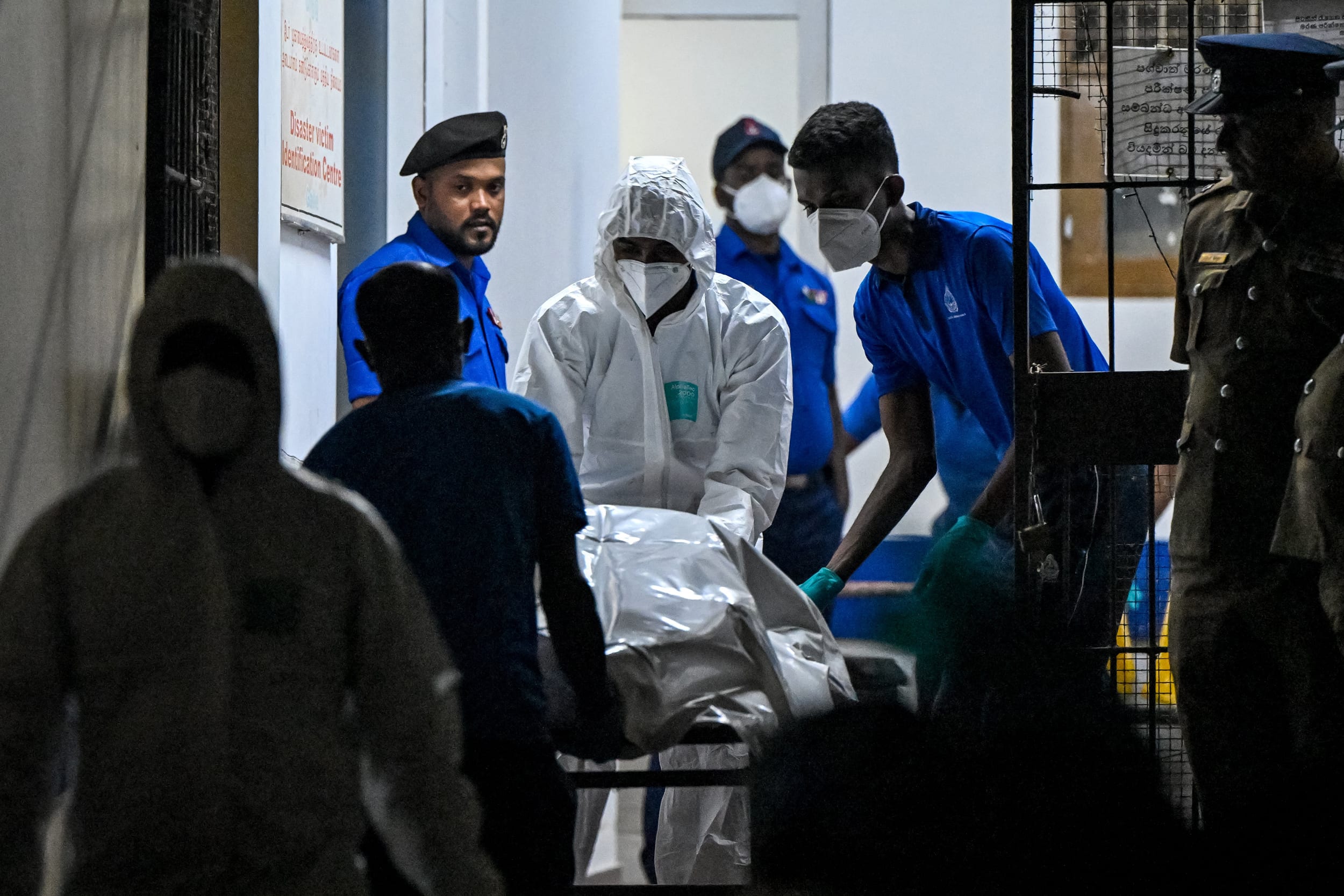 Healthcare workers carry the bodies of Iranian sailors killed in a U.S. torpedo attack on their frigate IRIS Dena off Sri Lanka's southern coast, at the mortuary of the Karapitiya hospital in Galle on March 4, 2026. 