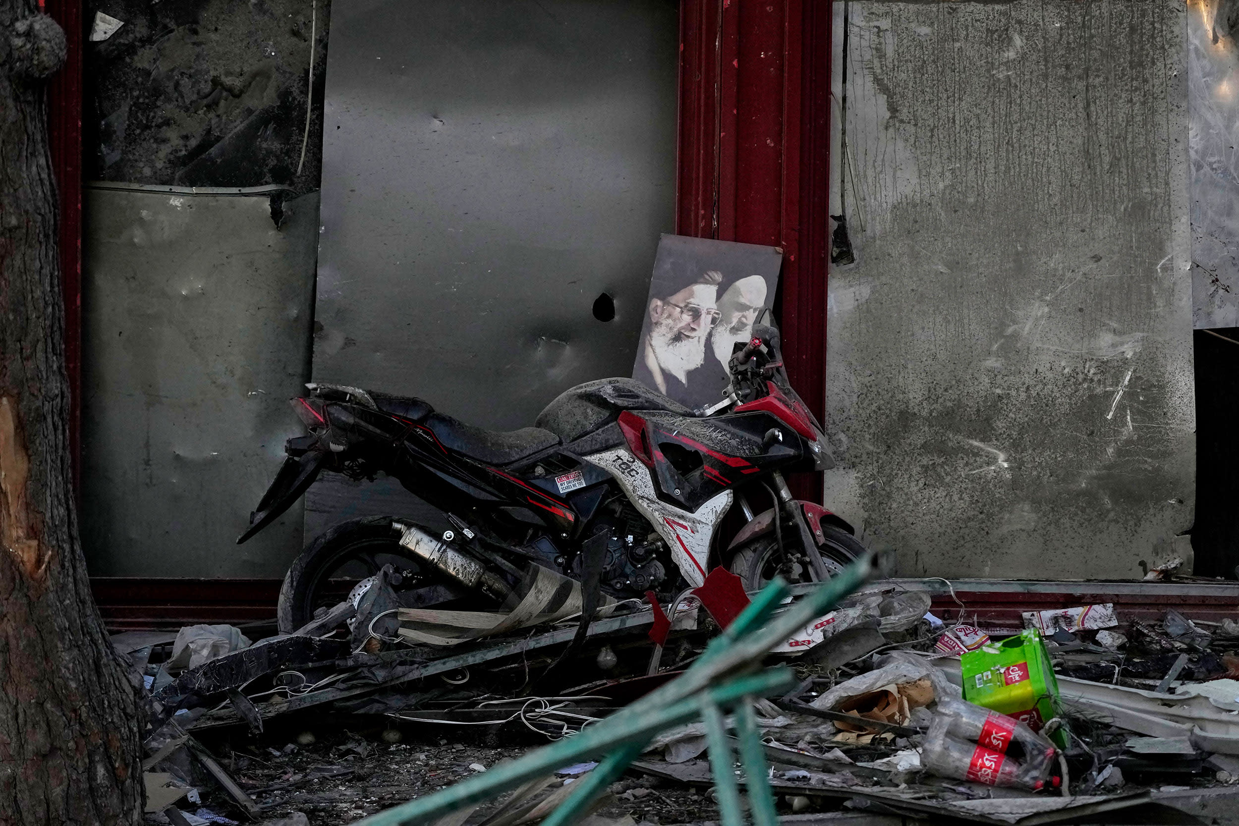 Image: A poster of the late Supreme Leader Ayatollah Ali Khamenei amongst debris