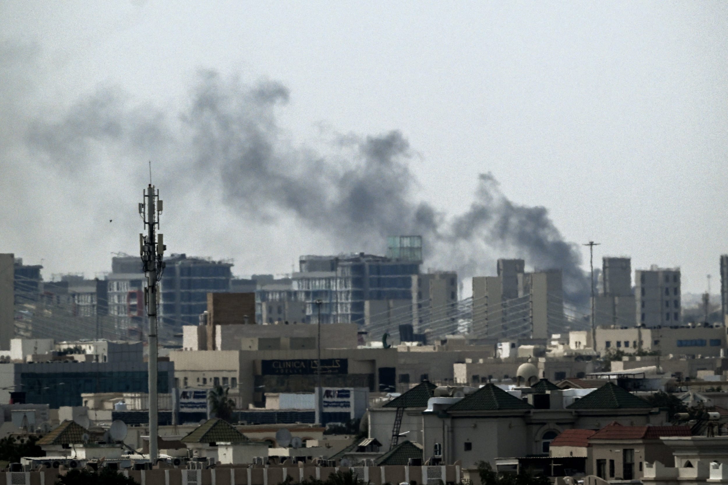 A plume of smoke rises over buildings in Doha on March 5, 2026