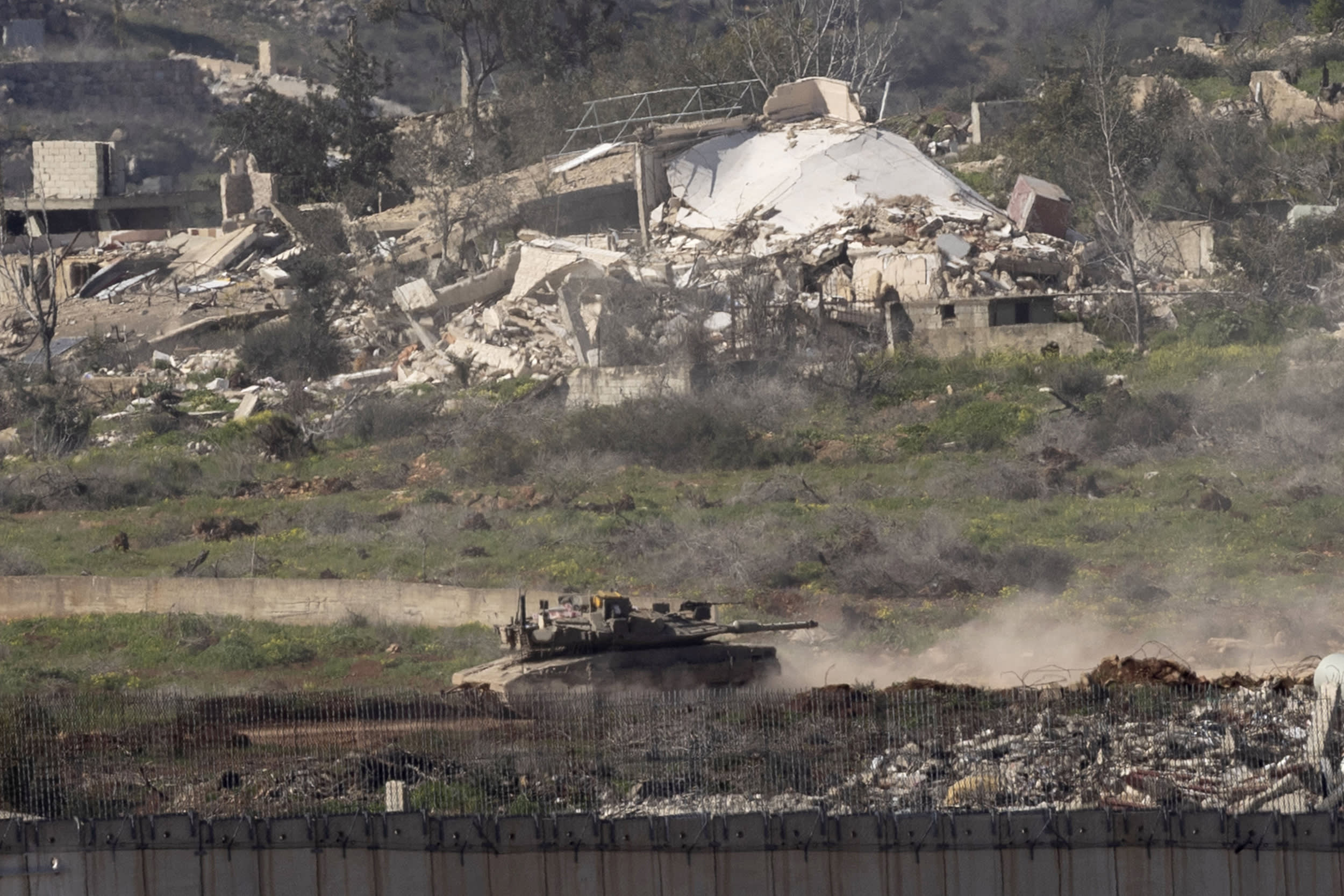 An Israeli tank moves in southern Lebanon near the border with Israel 