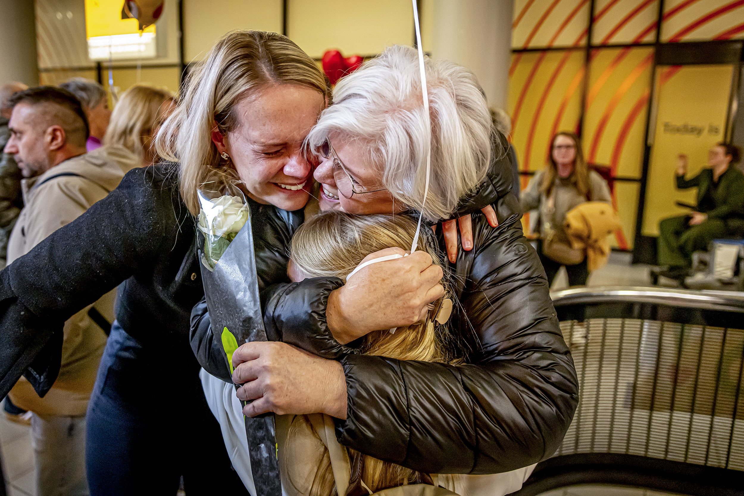 People hug their loved ones.