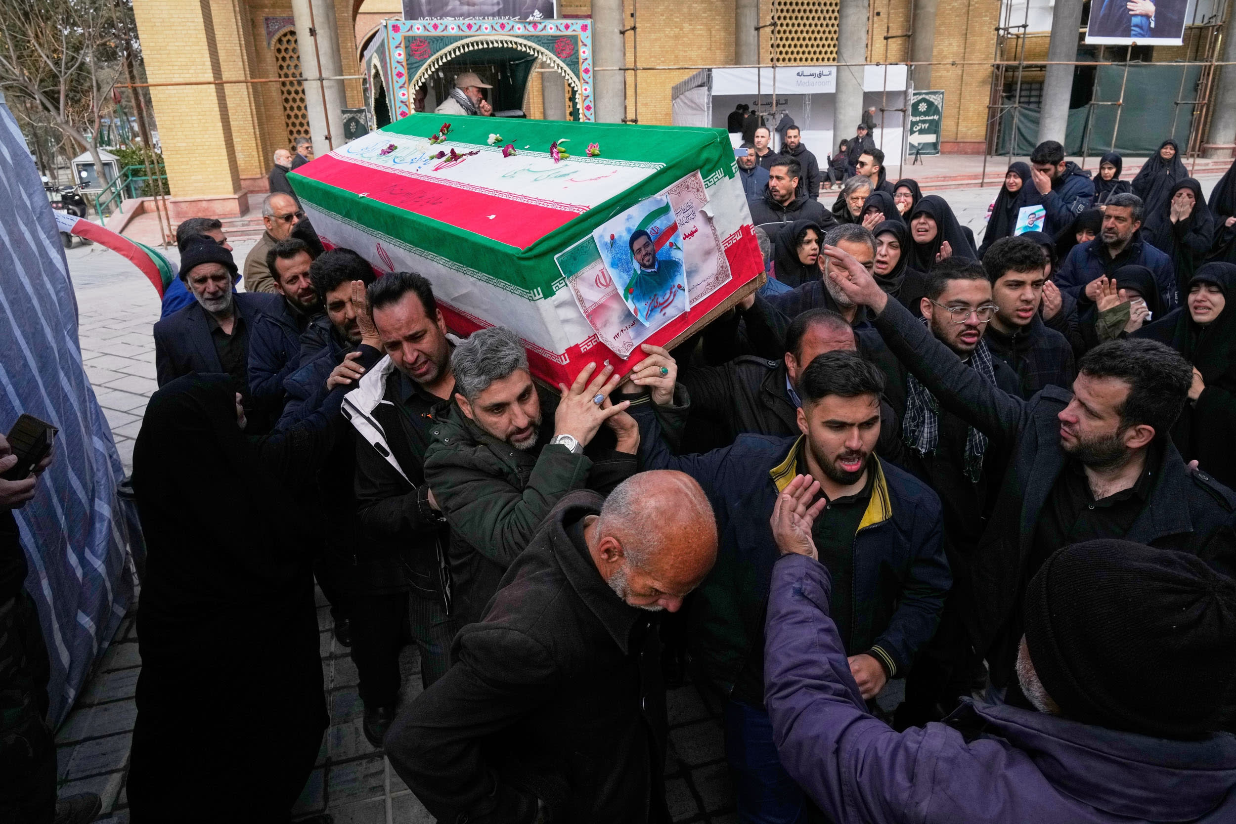 The coffin of Mehdi Hosseini, a man killed in a U.S.-Israeli strike, is carried for burial at Behesht-e Zahra cemetery in Tehran on March 9, 2026.